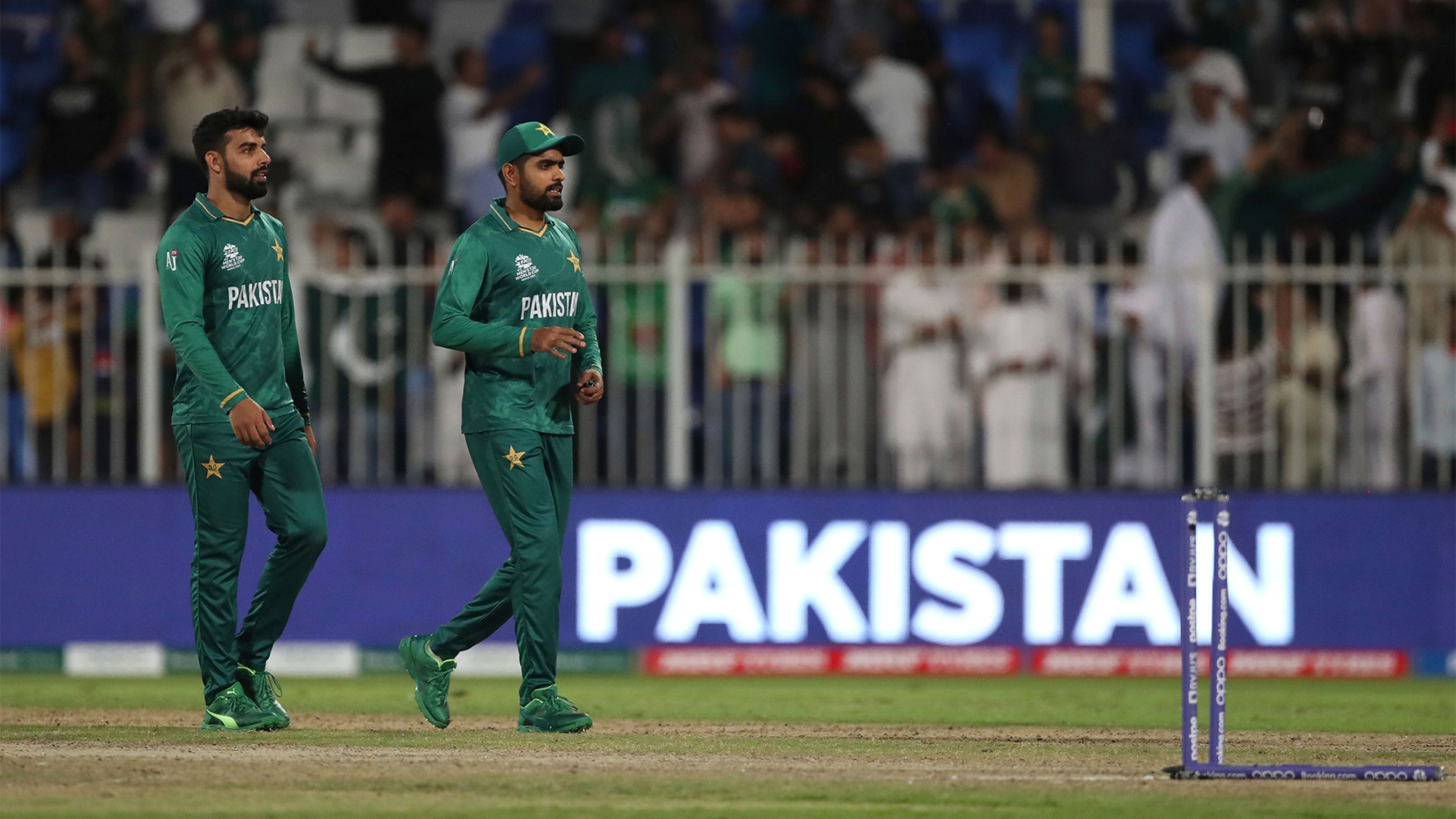 Pakistan's captain Babar Azam, right, and teammate Shadab Khan leave the field after their win in the Cricket Twenty20 World Cup match against Scotland in Sharjah, UAE Pakistan's captain Babar Azam, right, and teammate Shadab Khan leave the field after their win in the Cricket Twenty20 World Cup match against Scotland in Sharjah, UAE