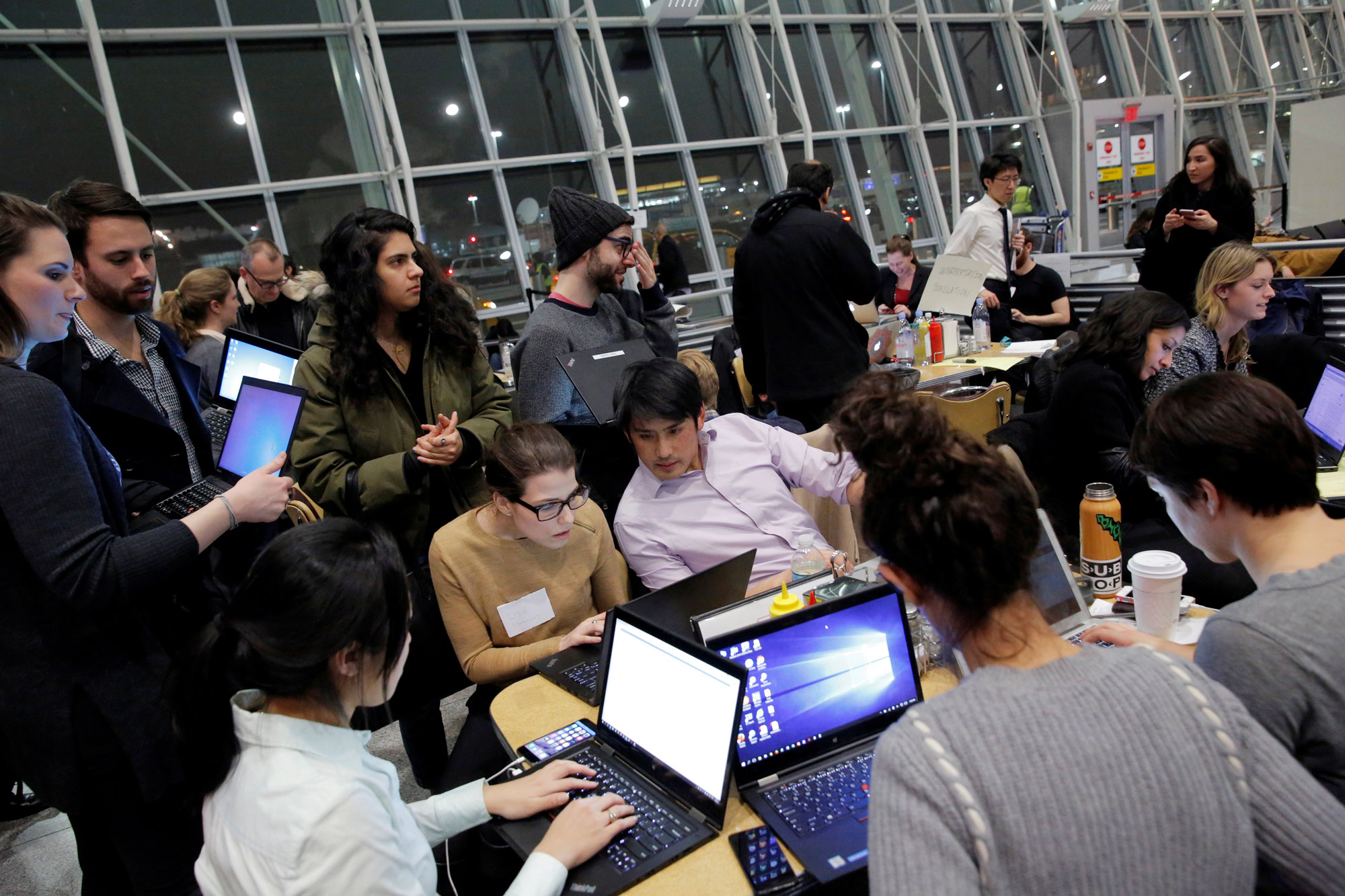 Volunteer lawyers work in a dining area of Terminal 4 to assist travelers detained as part of Donald Trump's travel ban in Terminal 4 at John F. Kennedy International Airport. Volunteer lawyers work in a dining area of Terminal 4 to assist travelers detained as part of Donald Trump's travel ban in Terminal 4 at John F. Kennedy International Airport.