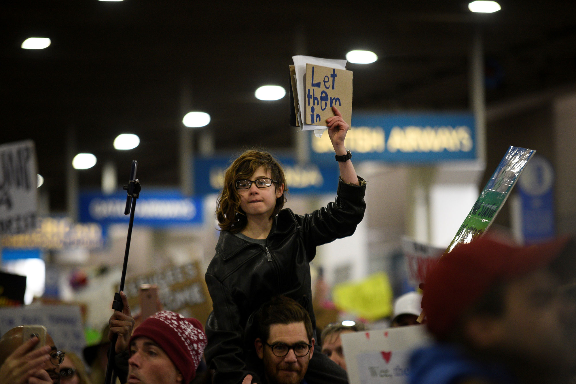 A young demonstrator holds a sign during anti-Donald Trump travel ban protests outside Philadelphia International Airport. A young demonstrator holds a sign during anti-Donald Trump travel ban protests outside Philadelphia International Airport.