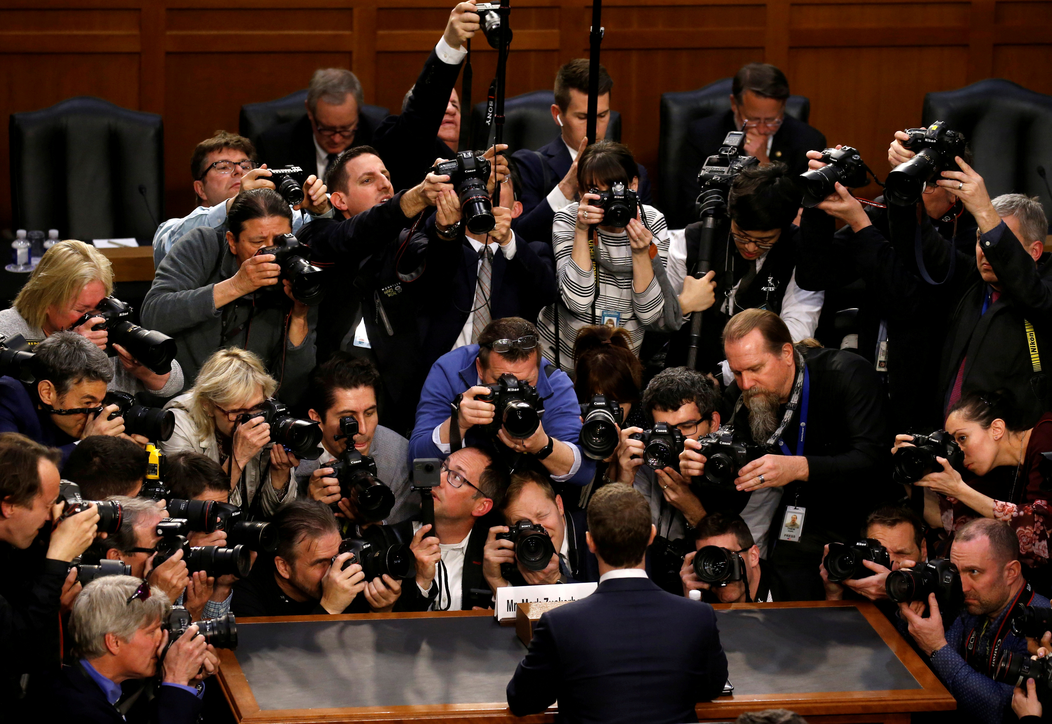 Facebook CEO Mark Zuckerberg is surrounded by members of the media as he arrives to testify before a Senate Judiciary and Commerce Committees in Washington, DC. The picture show's the back of Facebook CEO Mark Zuckerberg who is surrounded by photographers.