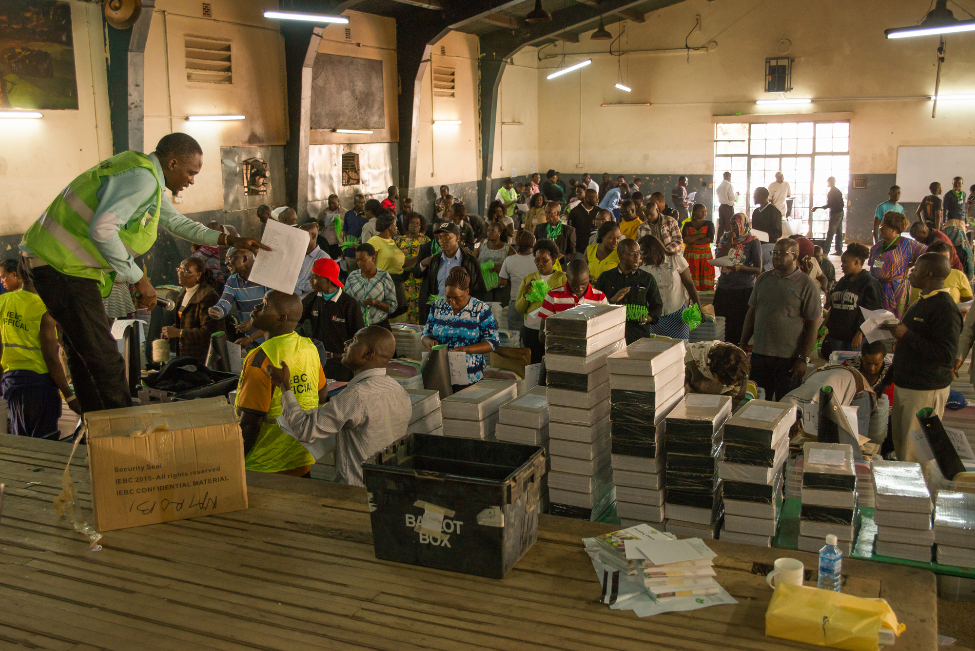 Officials with Kenya's Independent Electoral and Boundaries Commission distribute ballots and vote tallying forms to polling station officers before Tuesday's presidential election. Officials with Kenya's Independent Electoral and Boundaries Commission distribute ballots and vote tallying forms to polling station officers before Tuesday's presidential election.