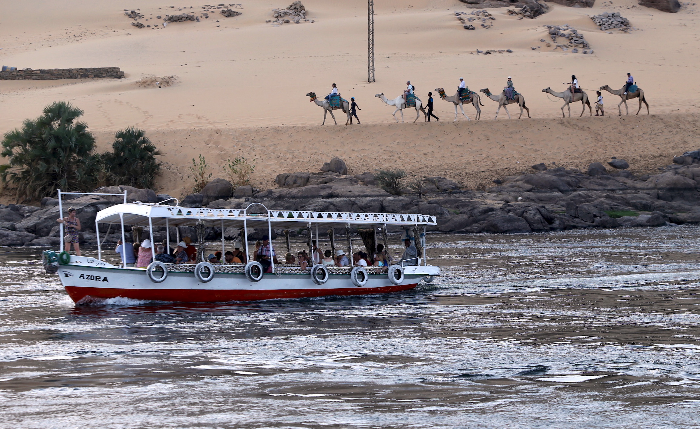 Tourists ride in a falluka (small boat) along the Nile river in Aswan on the way to Nubia, in southern Egypt. Tourists ride in a falluka (small boat) along the Nile river in Aswan on the way to Nubia, in southern Egypt.