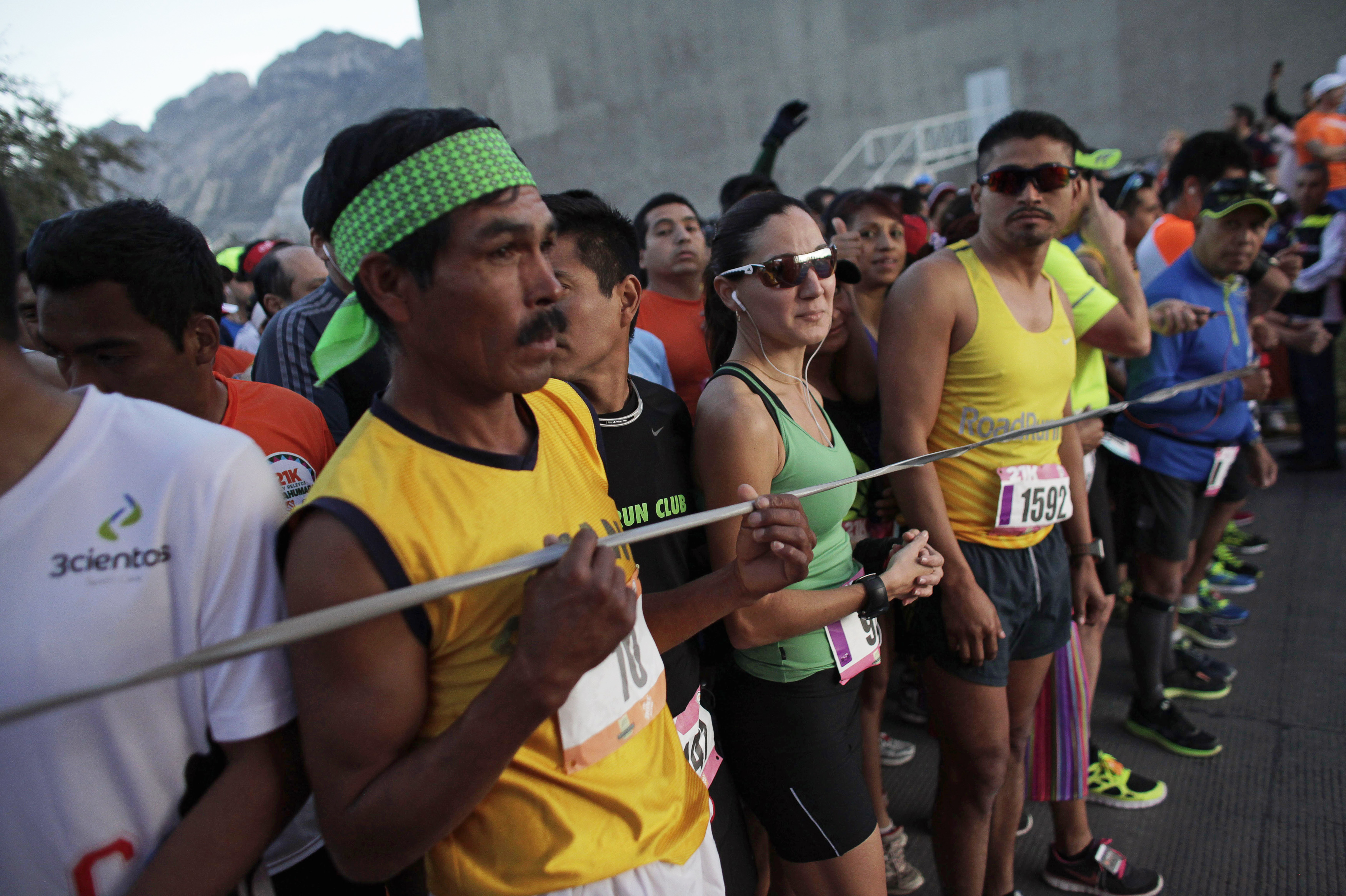 A Tarahumara man (front L) prepares next to other athletes before competing in a 21 km (13 miles) marathon in San Pedro Garza Garcia, on the outskirts of Monterrey, February 16, 2014. A Tarahumara man (front L) prepares next to other athletes before competing in a 21 km (13 miles) marathon in San Pedro Garza Garcia, on the outskirts of Monterrey, February 16, 2014.