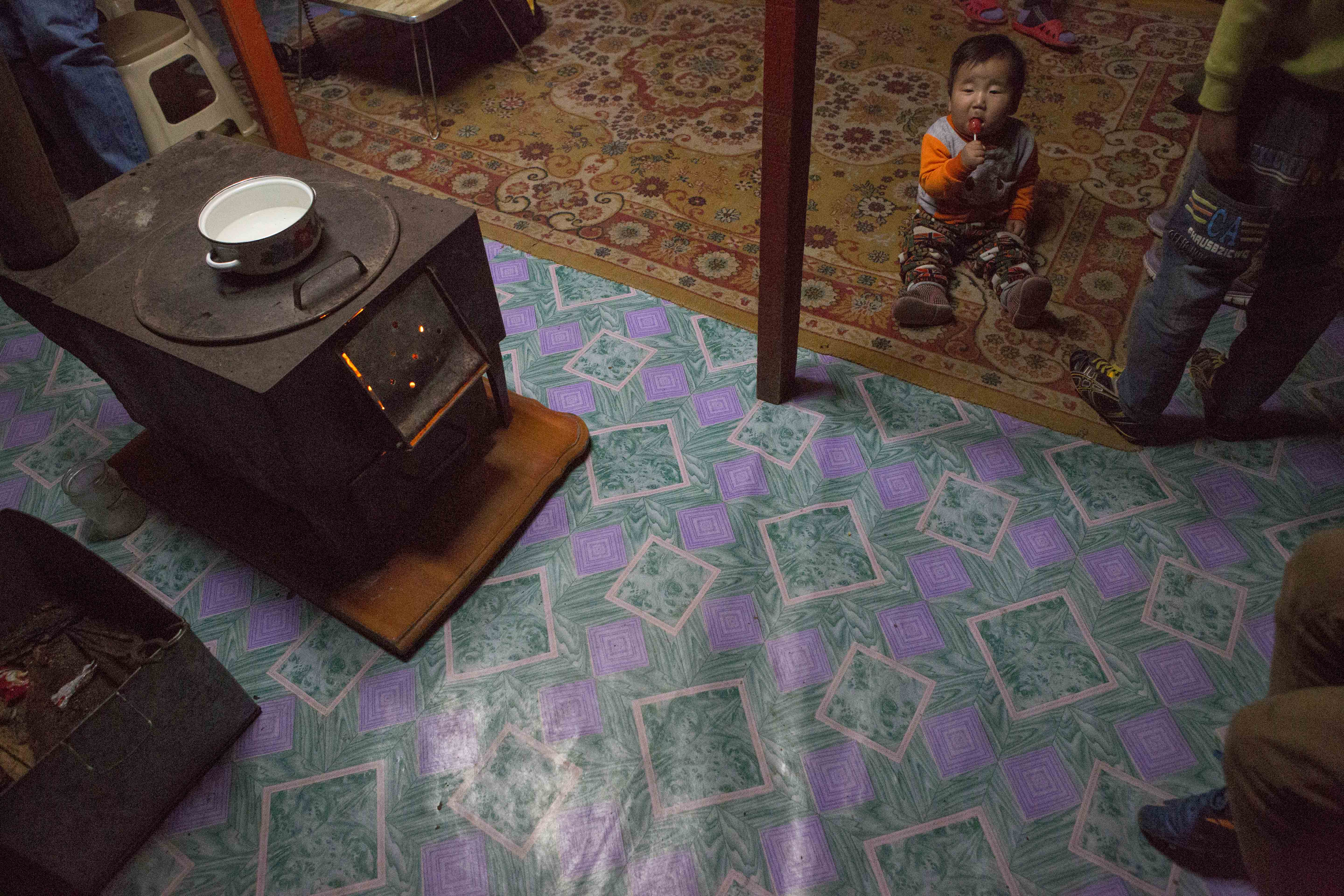 Eight month-old Munkh-erdene sits next to his family’s traditional stove in thier ger, or yurt in Ulaanbaatar. The stoves are meant to burn wood or animal dung, but many families use them to burn coal, causing a spike in air pollution in the winter.