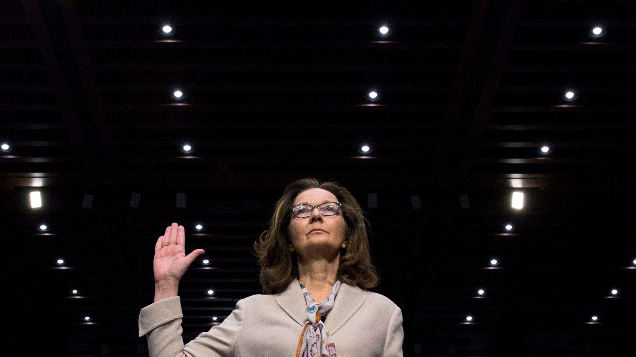 CIA director nominee and acting CIA Director Gina Haspel is sworn in to testify at her Senate Intelligence Committee confirmation, May 9, 2018. CIA director nominee Gina Haspel raises her right hand as she is sworn in to testify at her Senate Intelligence Committee confirmation, May 9, 2018.