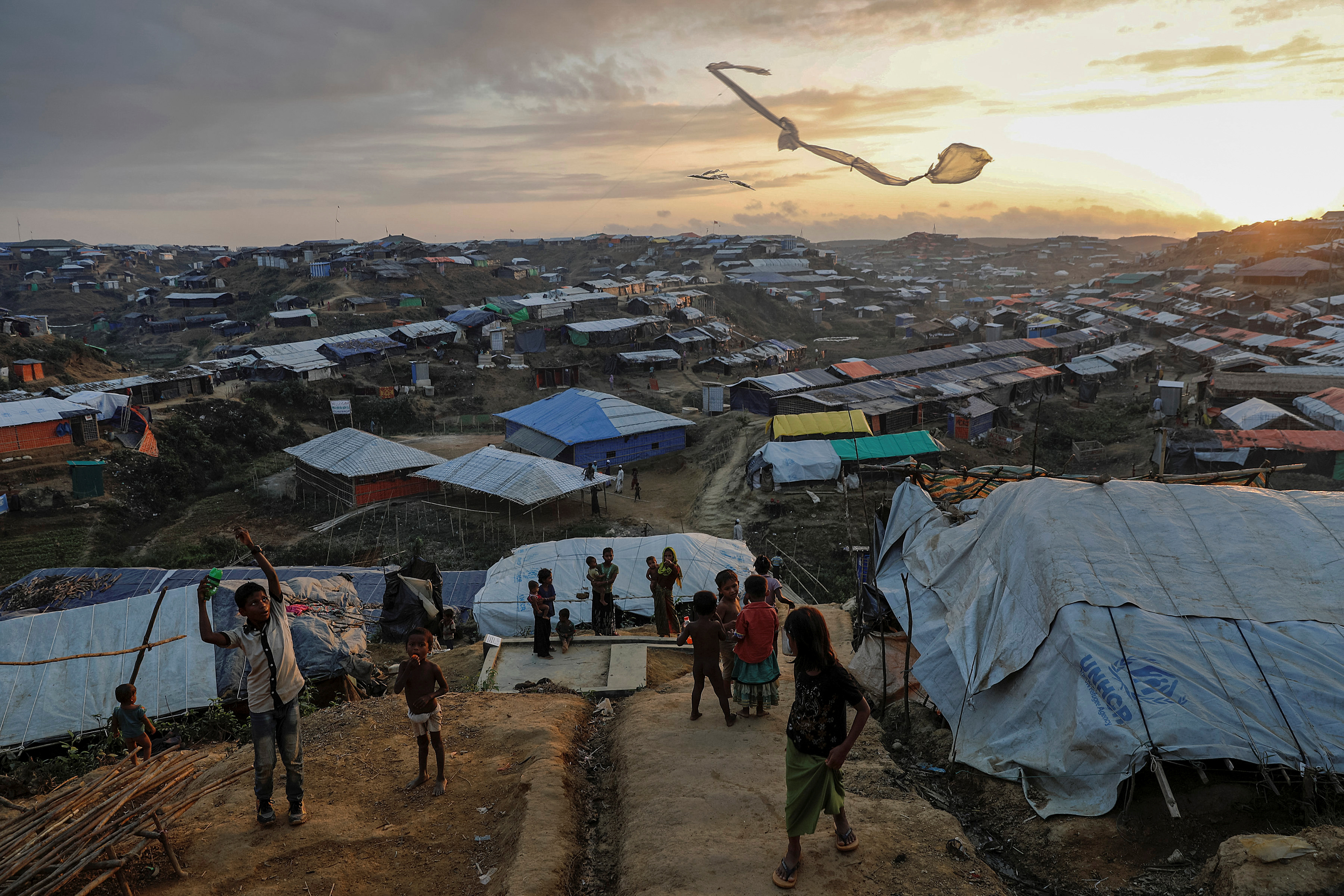 Rohingya refugee children fly improvised kites at the Kutupalong refugee camp near Cox's Bazar, Bangladesh. Rohingya refugee children fly improvised kites at the Kutupalong refugee camp near Cox's Bazar, Bangladesh.