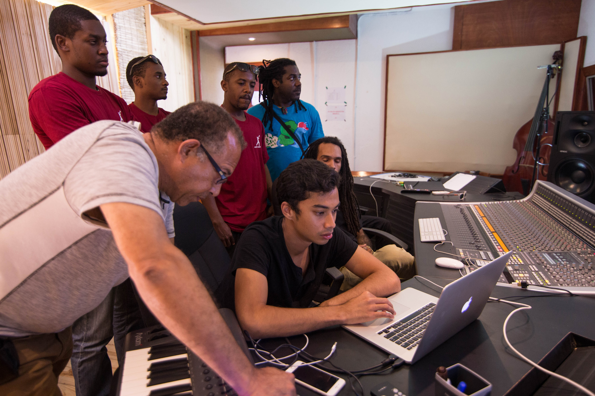 Michael Brun works with students at the Audio Institute in Jacmel, Haiti which he shared on his website in January 2016. He mentors students there and raises money for scholarships. Michael Brun sits at a digital audio workstation with students at the Audio Institute in Jacmel, Haiti.