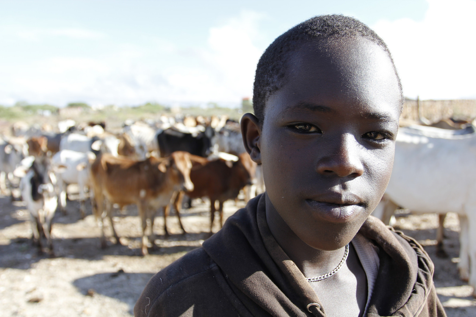 Kenyan Climate Change A child stands in front of a herd of cows in Samburu County in Kenya, one of the many tropical countries that would have a larger hit to its overall gross domestic product if the overall global temperature continues to steadily rise. Climate change has le