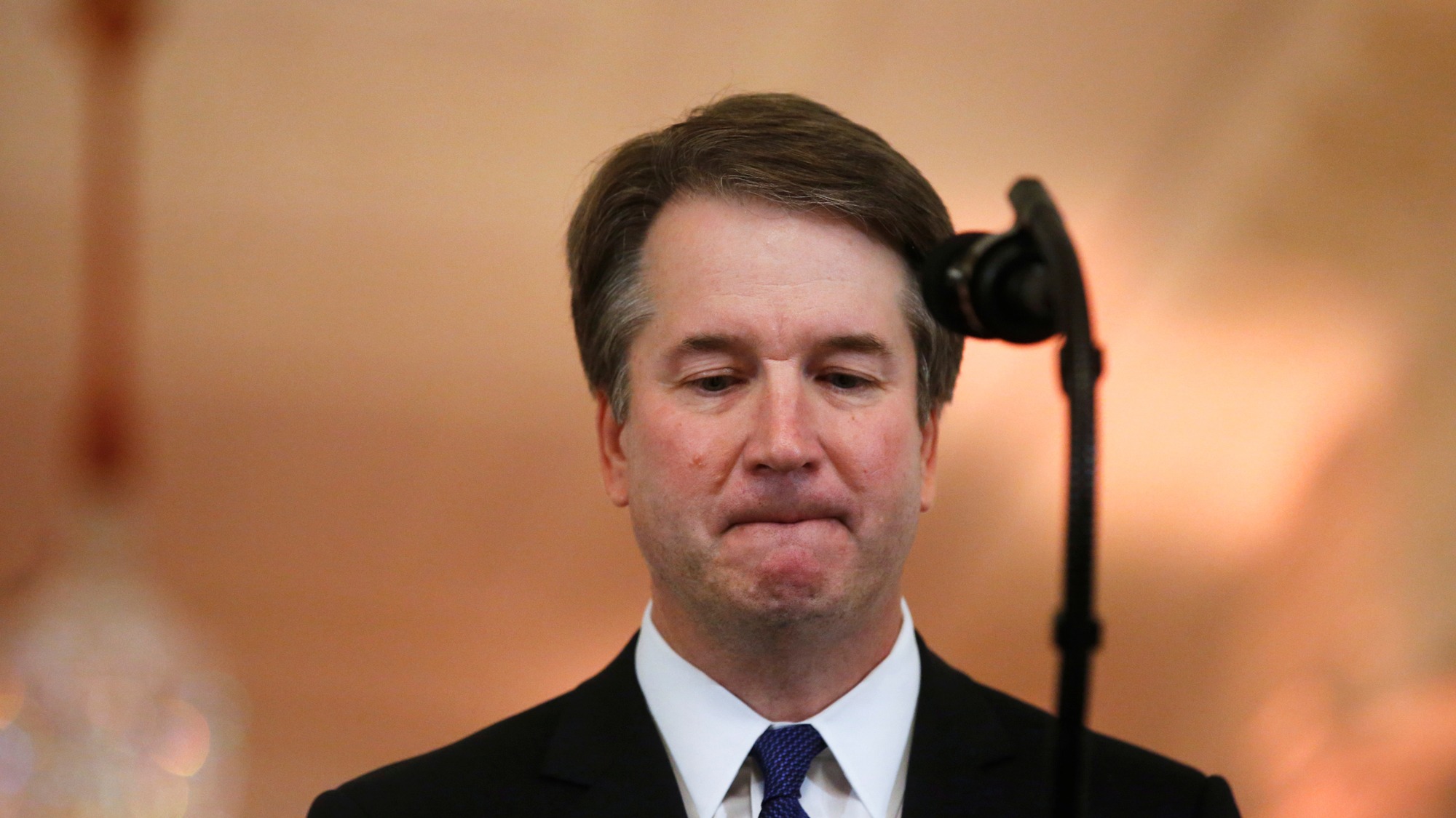 US Supreme Court nominee judge Brett Kavanaugh in the East Room of the White House, July 9, 2018. US Supreme Court nominee judge Brett Kavanaugh is shown looking down at a microphone.