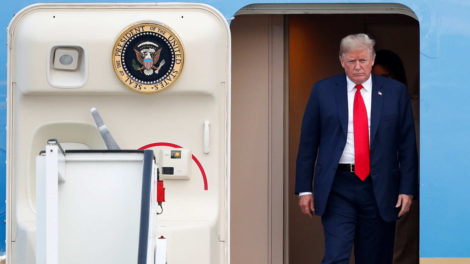 US President Donald Trump exits Air Force One in Brussels, July 10, 2018. US President Donald Trump is shown exiting Air Force One with the door of the aircraft ajar.