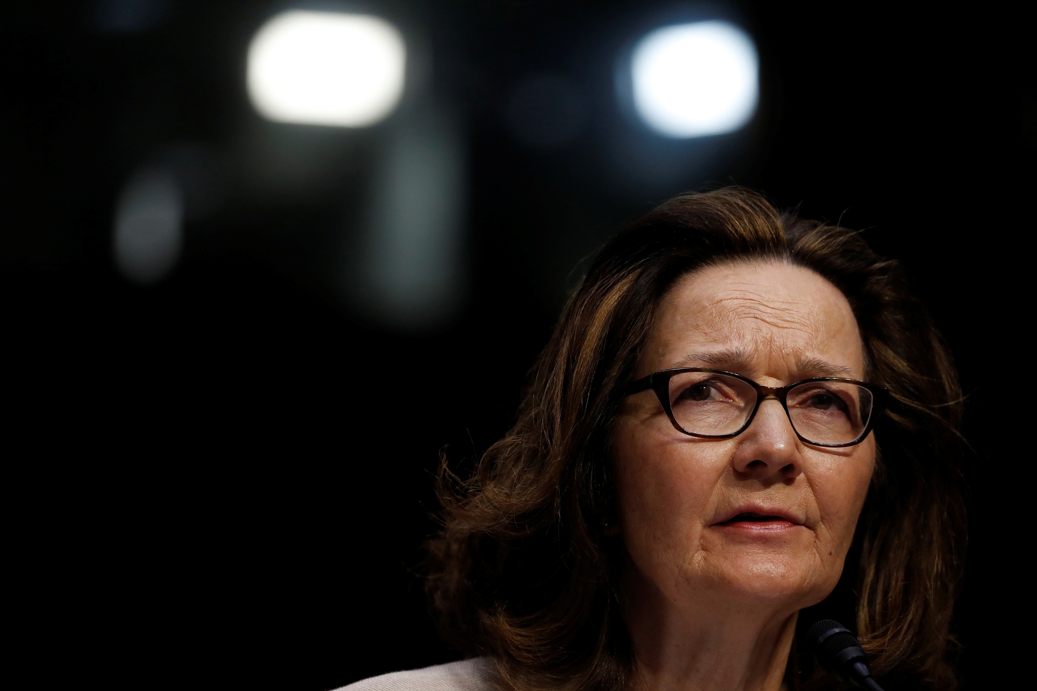 CIA Director Gina Haspel testifies at her confirmation hearing before the Senate Intelligence Committee. CIA Director Gina Haspel, wearing dark rimmed glasses, looks right in the medium cropped portrait.