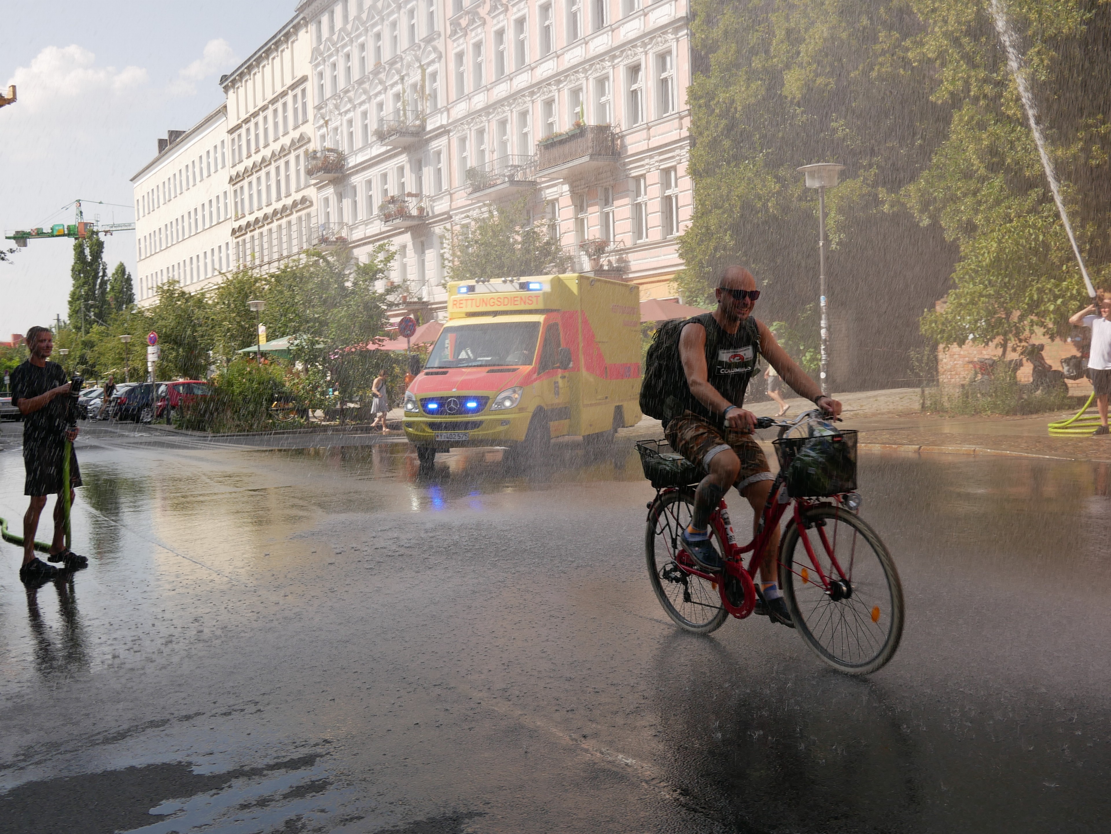 Firefighters blast water in Berlin in mid-August, providing relief from the heat. This is among the few ways to cool off in a city with little air conditioning. Firefighters blast water in Berlin in mid-August, providing relief from the heat. This is among the few ways to cool off in a city with little air conditioning.