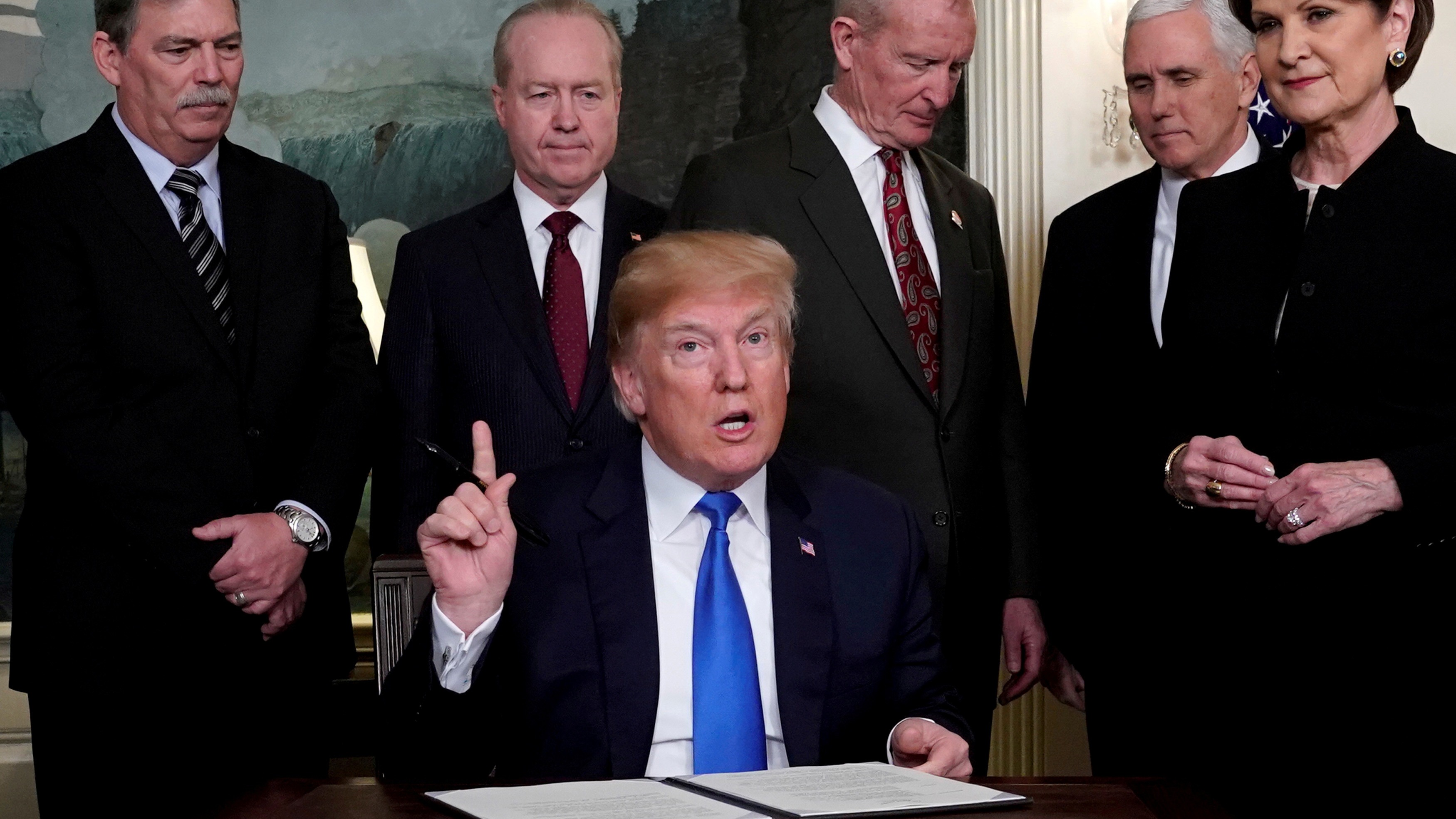 President Donald Trump, surrounded by business leaders and administration officials, prepares to sign a memorandum on intellectual property tariffs on high-tech goods from China, at the White House in Washington, March 22, 2018. President Donald Trump, surrounded by business leaders and administration officials, prepares to sign a memorandum on intellectual property tariffs on high-tech goods from China, at the White House in Washington, March 22, 2018.