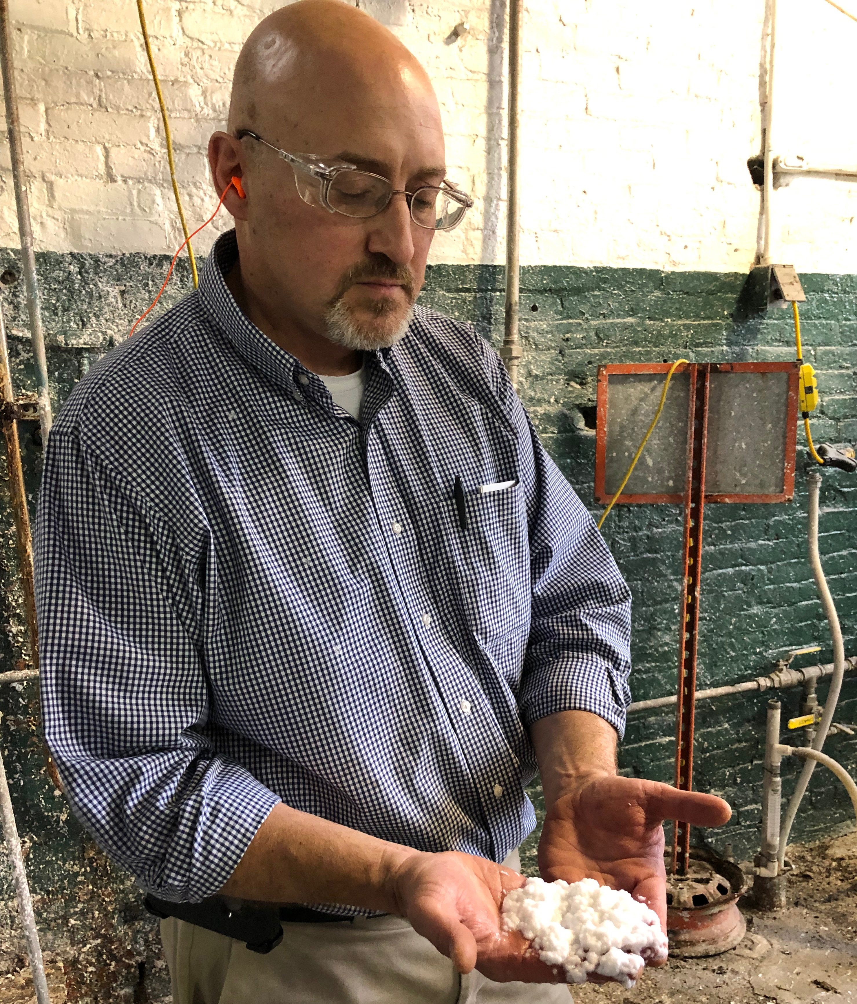 Early in the process, pulp fiber has a consistency and look that’s similar to oatmeal. Here, Paul Graver with Mohawk paper mill, holds an example. Early in the process, pulp fiber has a consistency and look that’s similar to oatmeal. Here, Paul Graver with Mohawk, holds an example.