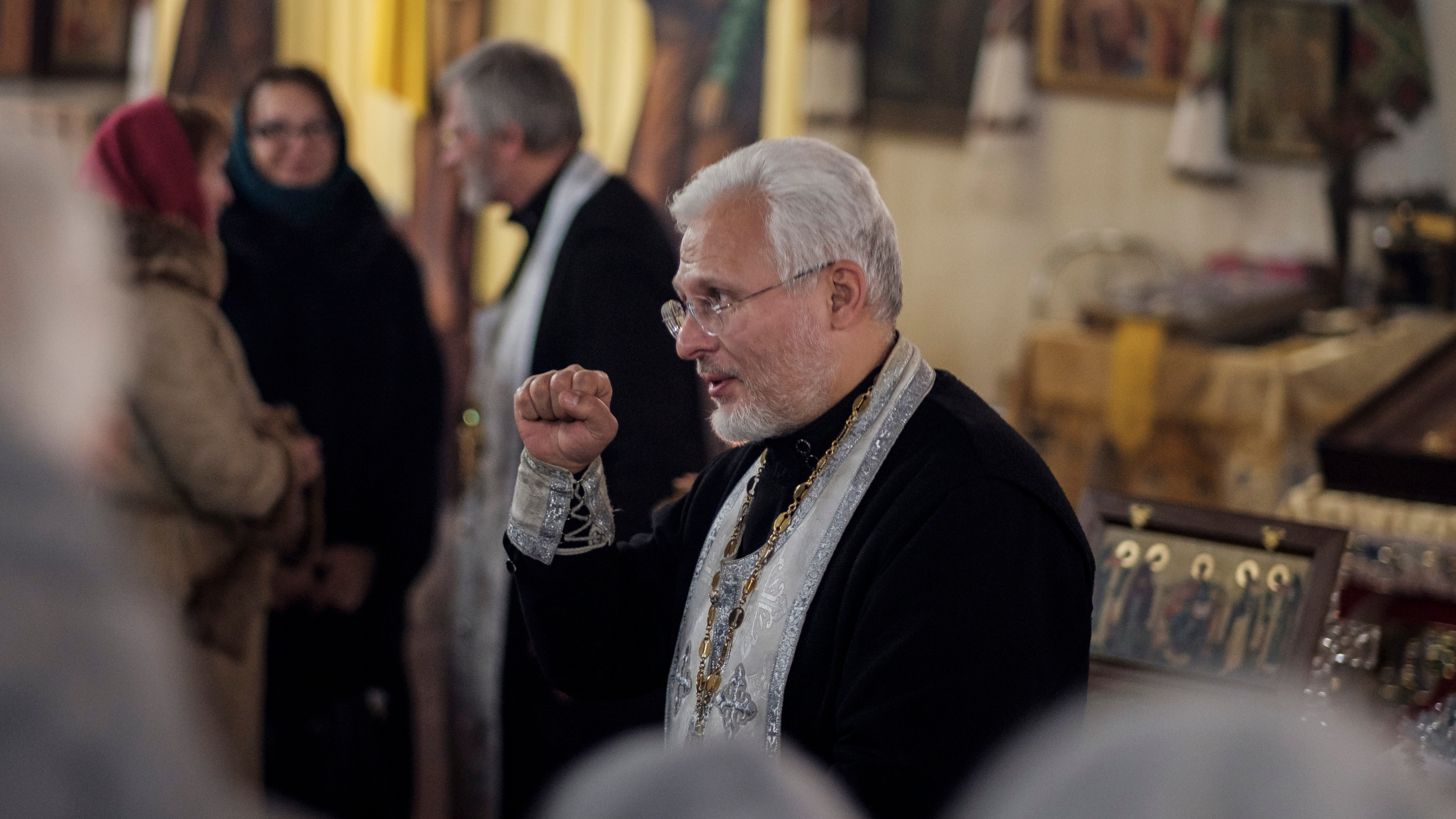 Father Hennadiy Rokhmaniyko, a priest at St. John the Theologian Cathedral, said official recognition is long overdue. He sees it as an affirmation of independence for Ukraine. A priest makes a fist.