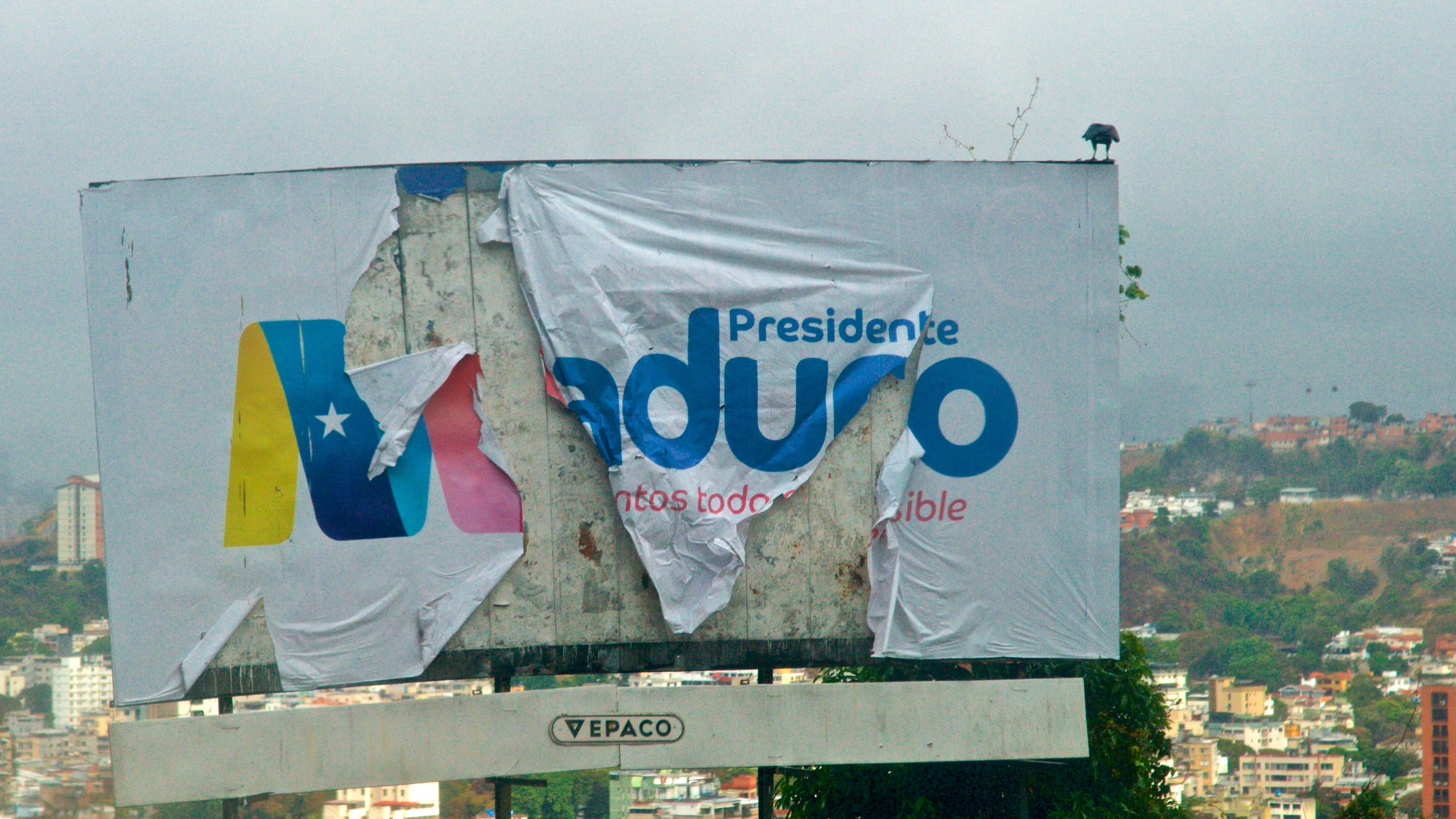 President Nicolás Maduro's 2018 reelection campaign sign, almost a year after the election, Caracas, Venezuela, Feb. 26, 2019. Torn up election sign
