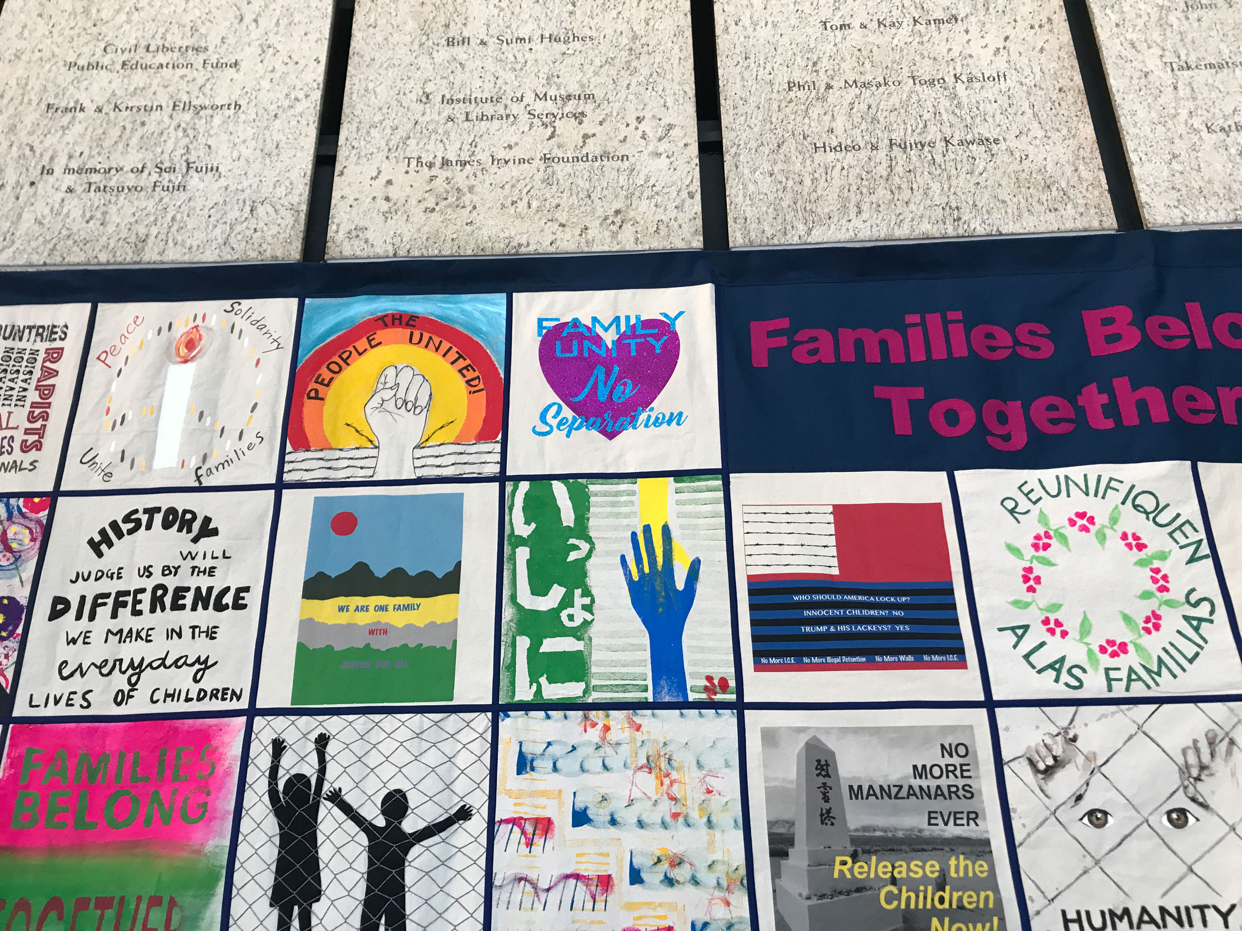 A quilt displayed at the annual National Day of Remembrance Ceremony at the Japanese American National Museum in February connected the asylum experience with the Japanese American experience. A quilt shown with many colorful squares with one that says, "No more Manzanars ever."