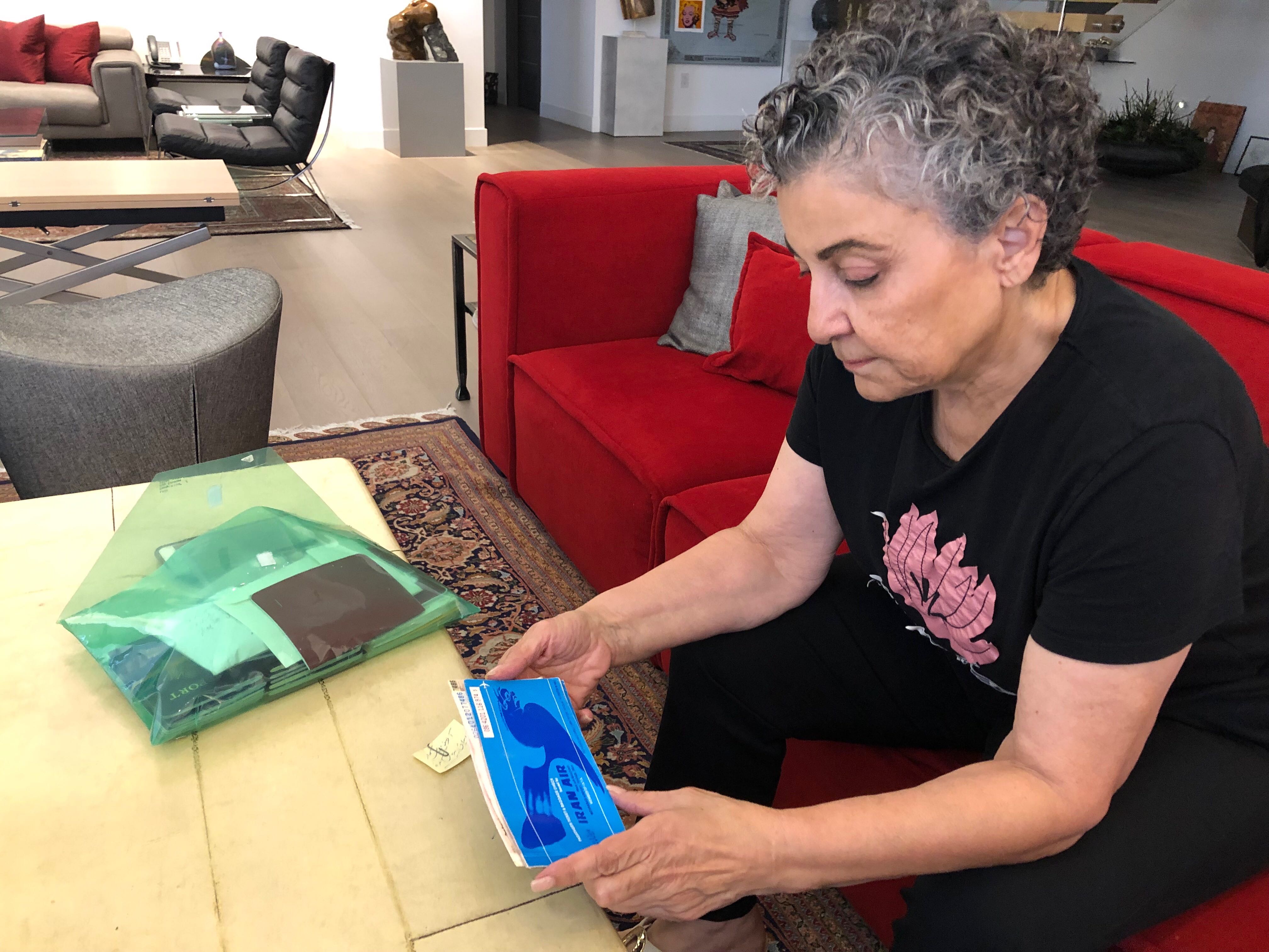 Iranian American radio host Homa Sarshar at her home in Los Angeles. She holds the plane ticket that brought her to the US more than 40 years ago. Iranian American radio host Homa Sarshar at her home in Los Angeles. She holds the plane ticket that brought her to the US more than 40 years ago.