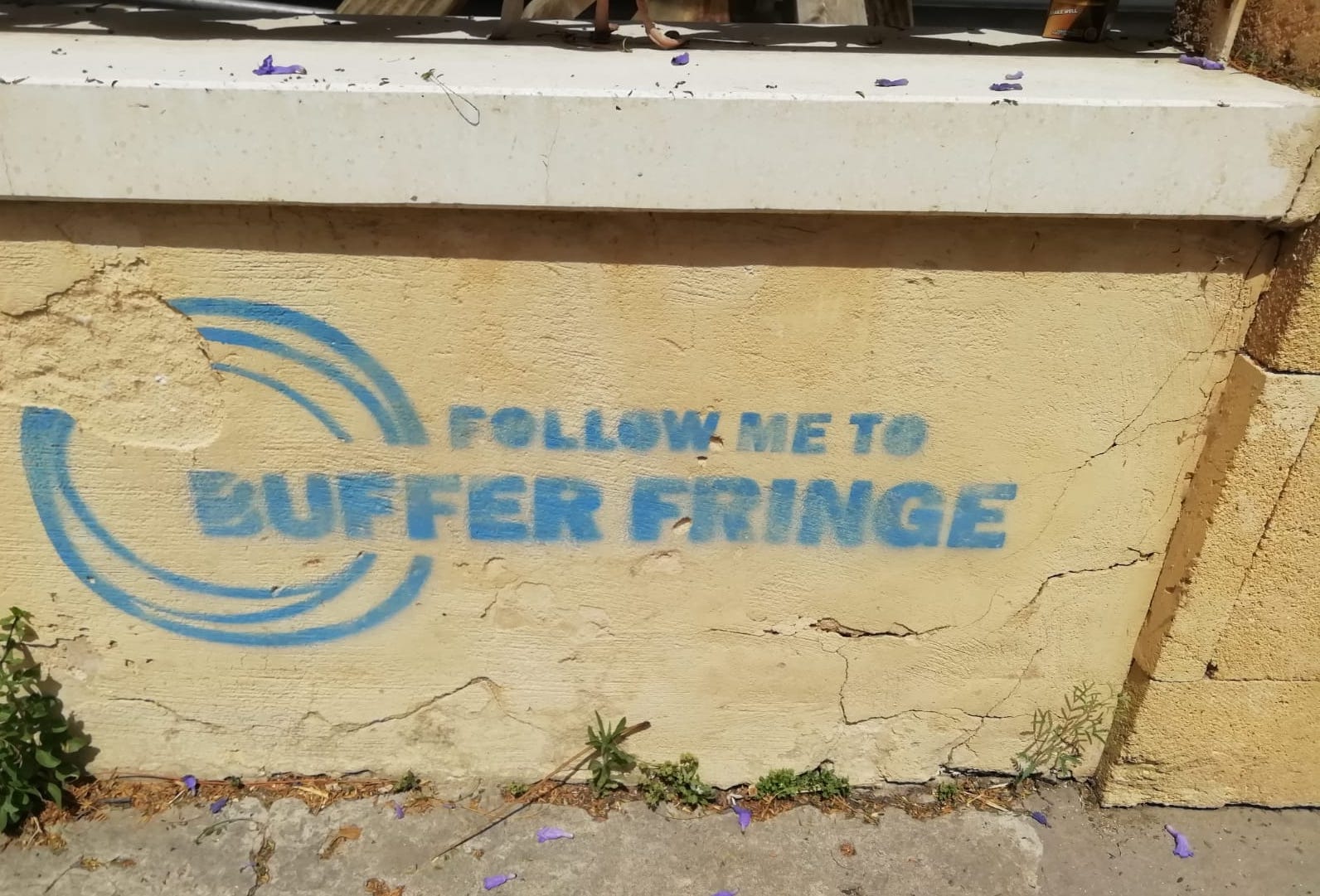Graffiti seen on wall in Nicosia in blue lettering reads "Follow Me to Buffer Fringe"