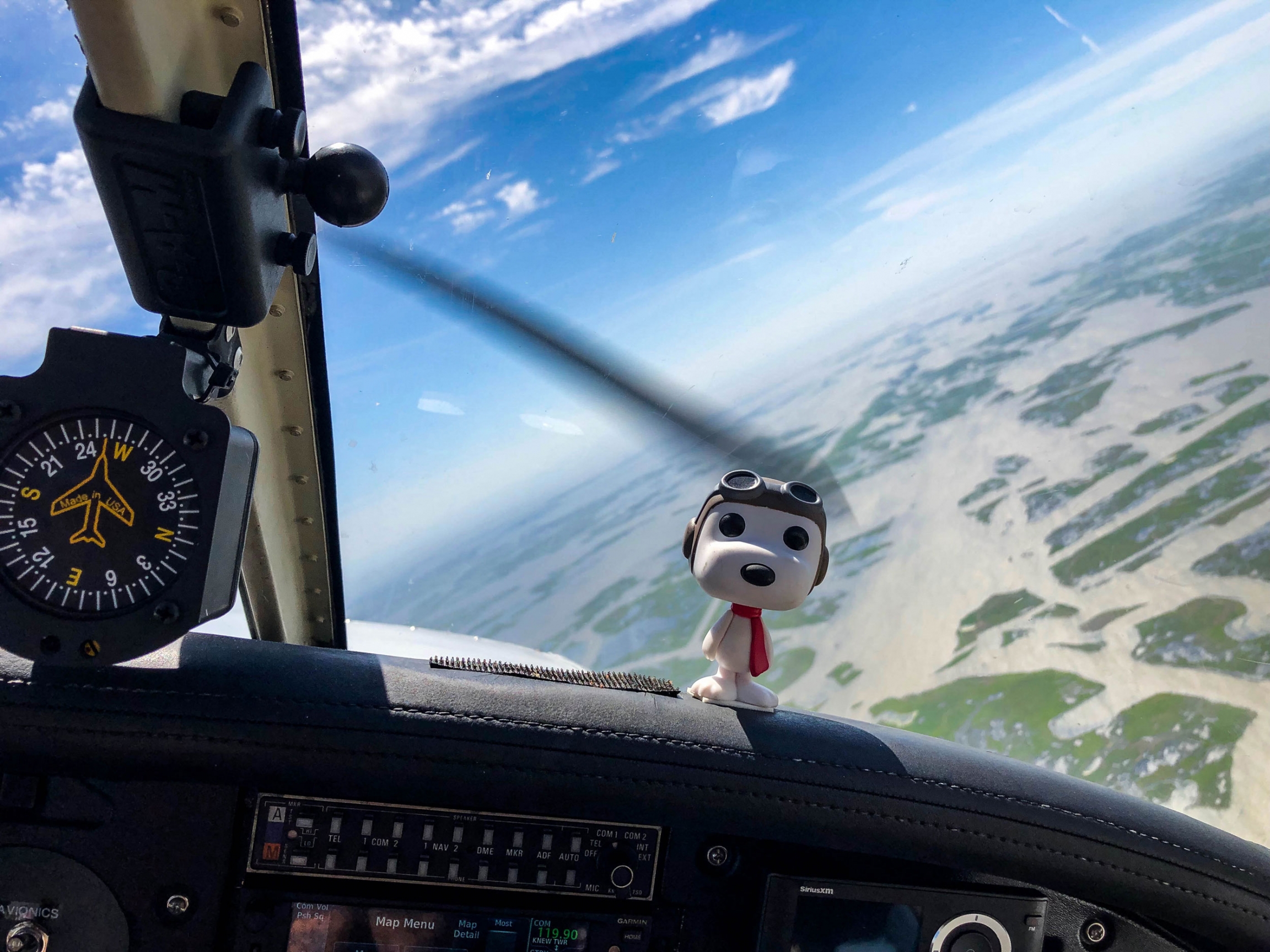 Pilot Owen Bordelon keeps a Snoopy figurine on the dashboard of his four-seat plane. A figurine of Snoopy is shown on the dashboard of four-seat plane with aviator attire.