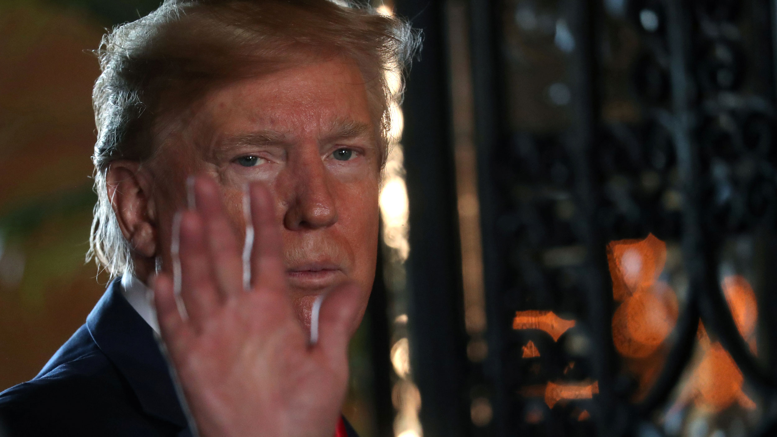 US President Donald Trump waves to the news media after participating in a video teleconference in Palm Beach, Florida, on Dec. 24, 2019. US President Donald Trump is shown in a close-up photo waving.