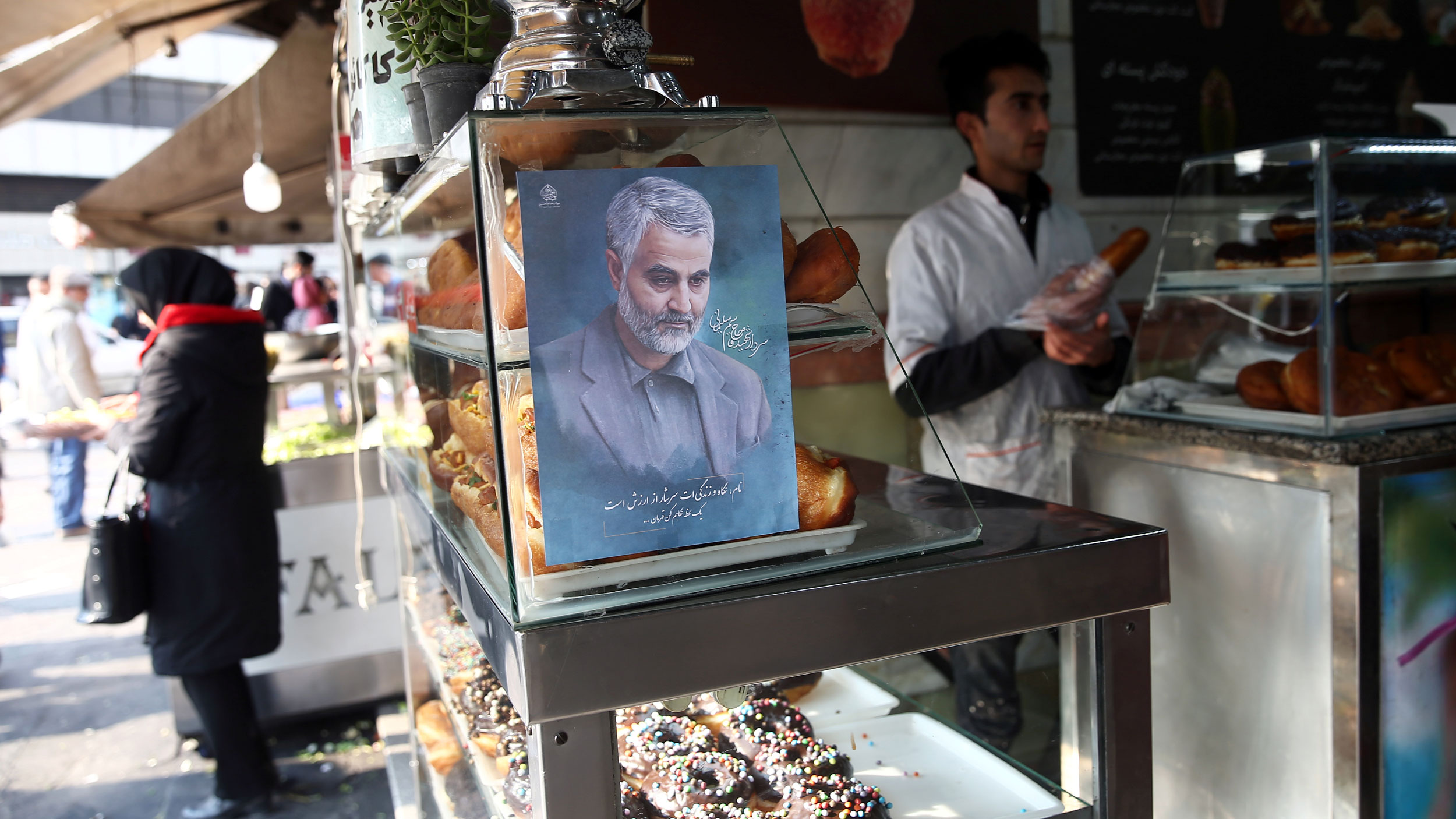 A picture of Iranian Maj. Gen. Qasem Soleimani, who was killed in an airstrike at Baghdad airport, is seen at a confectionery shop in Tehran, Iran, Jan. 7, 2020. A portrait painint of of Iranian Maj. Gen. Qasem Soleimani is shown on a glass case in a confectionery shop.