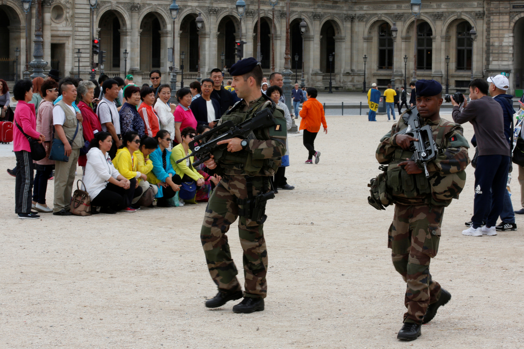 France Belgium Terror Warnings 2016 6 15 Chinese tourists take group pictures as French army soldiers patrol near the Louvre Museum Pyramid's main entrance in Paris, France, June 13, 2016 as the French capital is under high security during the UEFA 2016 European Championship.