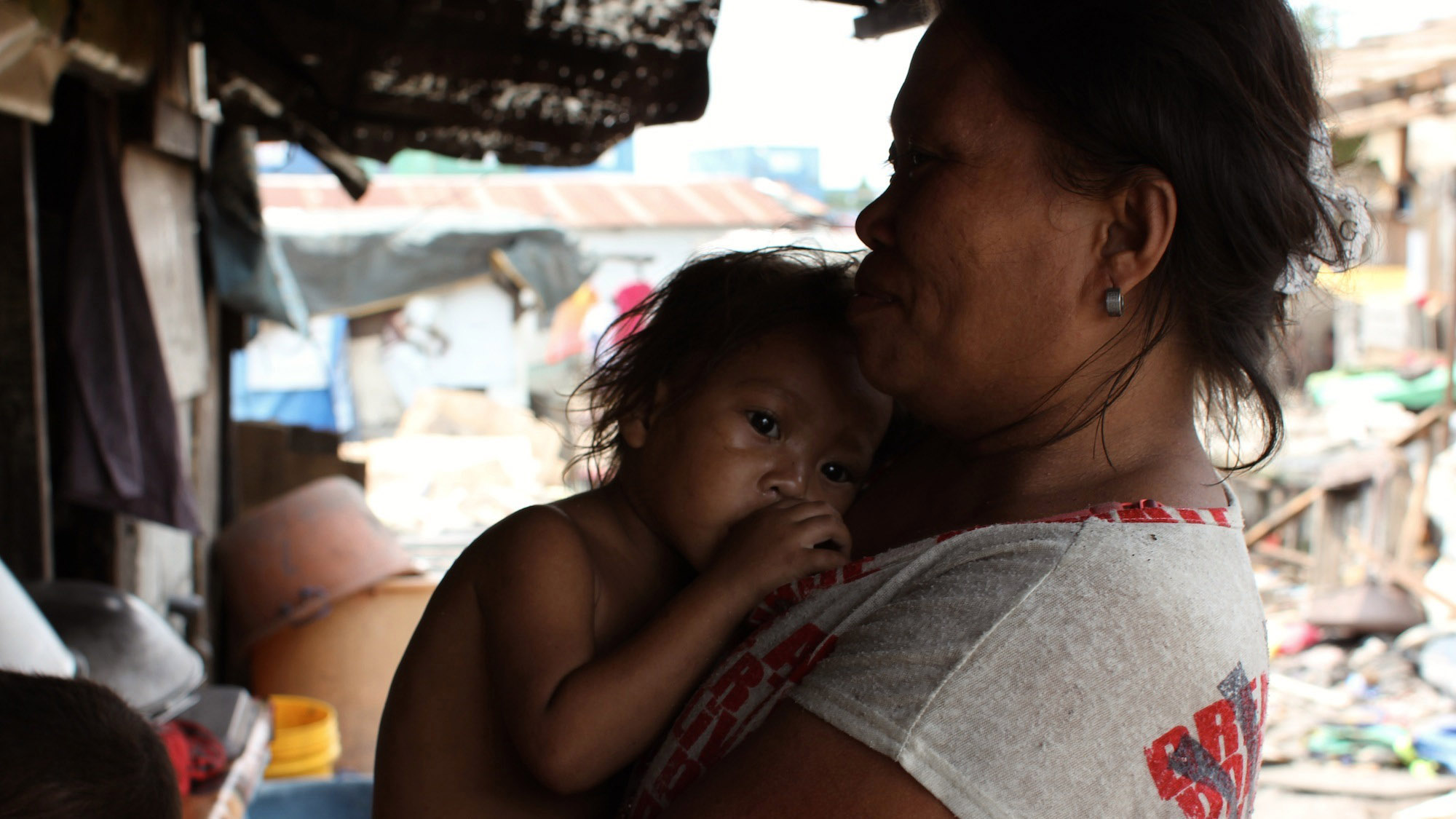 A woman clutches her baby girl. Loste says the best part of having a big family is when they’re all together, but she says, it’s probably just as nice with a small family. A woman clutches her baby girl. Loste says the best part of having a big family is when they’re all together, but she says, it’s probably just as nice with a small family.