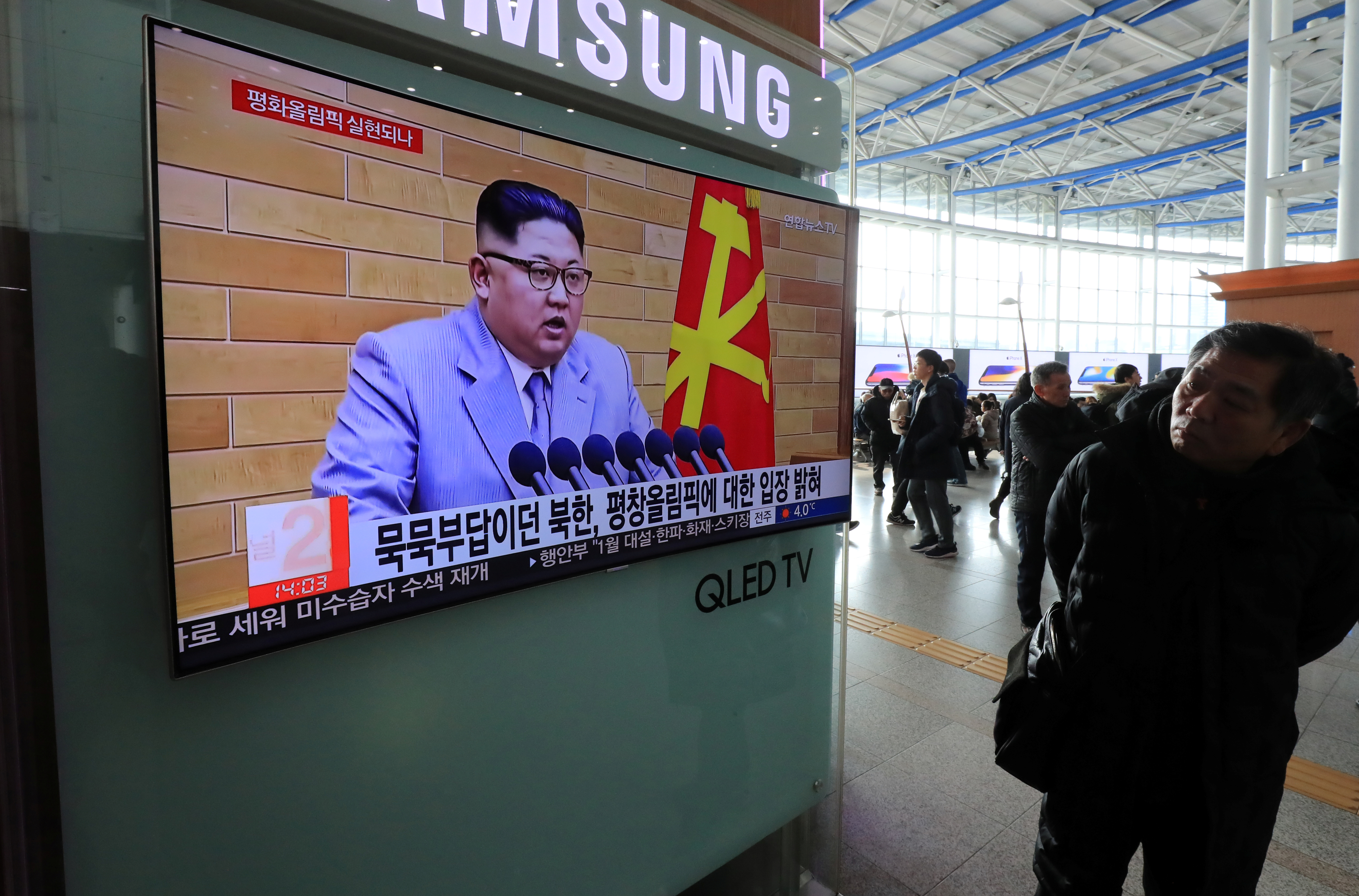 A man in Seoul, South Korea, watches a TV broadcasting a news report on North Korea's leader Kim Jong-un speaking during a New Year's Day speech. A man in Seoul, South Korea, watches a TV broadcasting a news report on North Korea's leader Kim Jong-un speaking during a New Year's Day speech.