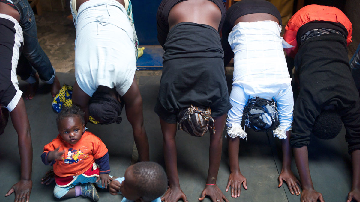 A yoga class for girls and young mothers in the slum of Kariobangi. Mothers bring their kids to class. A yoga class for girls and young mothers in the slum of Kariobangi. Mothers bring their kids to class.