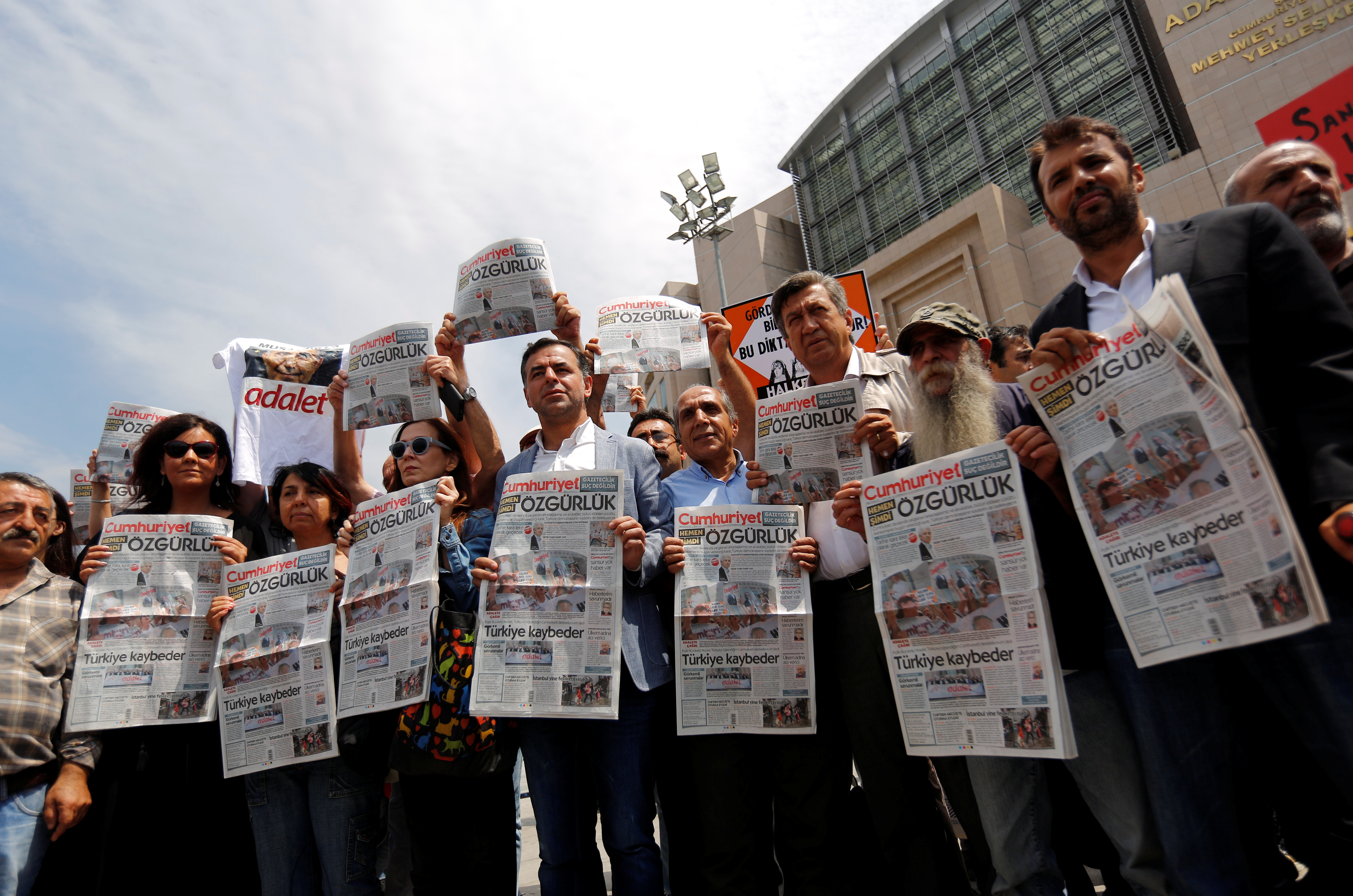 Press freedom activists hold copies of the opposition newspaper Cumhuriyet during a demonstration in solidarity with the jailed members of the newspaper outside a courthouse, in Istanbul, Turkey, July 28, 2017. Press freedom activists hold copies of the opposition newspaper Cumhuriyet during a demonstration in solidarity with the jailed members of the newspaper outside a courthouse, in Istanbul, Turkey, July 28, 2017.
