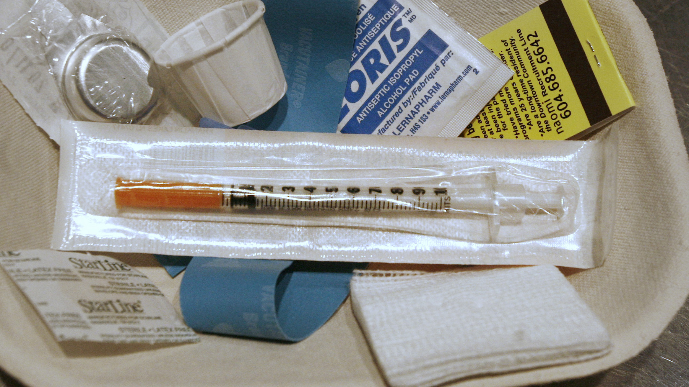 A small kit of supplies containing syringes, bandaids and antiseptic pads waits to be used by a drug addict inside a safe injection site on Vancouver, British Columbia's eastside August 23, 2006. Nearly a decade later, the city will be offering free heroi A small kit of supplies containing syringes, bandaids and antiseptic pads waits to be used by a drug addict inside a safe injection site on Vancouver, British Columbia's eastside August 23, 2006. Nearly a decade later, the city will be offering free heroi