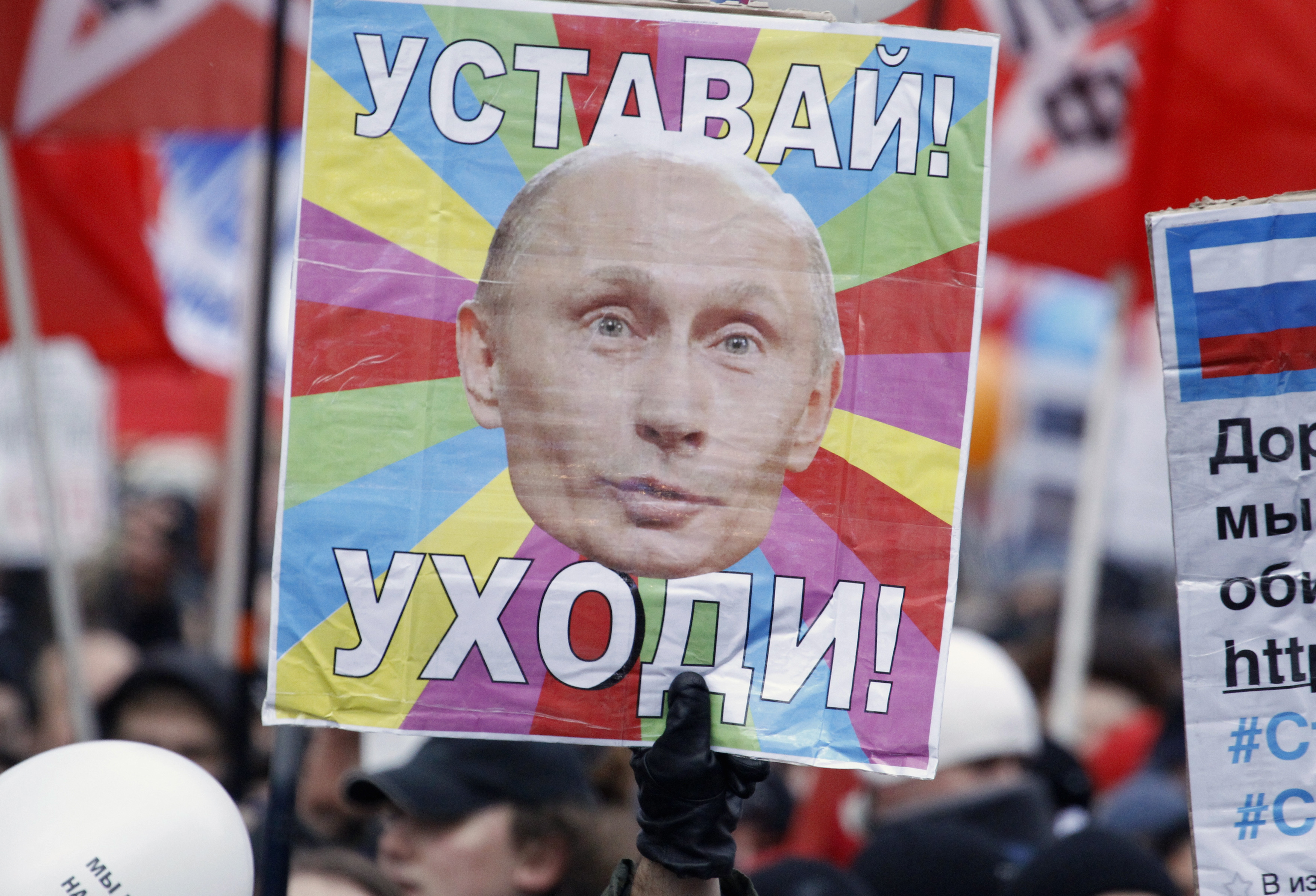 Anti-government Russian demonstrators took to the streets in December 2011, increasing pressure on Vladimir Putin as he sought a new term as Russian president. The placard reads "Get tired! Leave!" Anti-government Russian demonstrators took to the streets in Decembe, 2011, increasing pressure on Vladimir Putin as he sought a new term as Russian president. The placard reads "Get tired! Leave!"