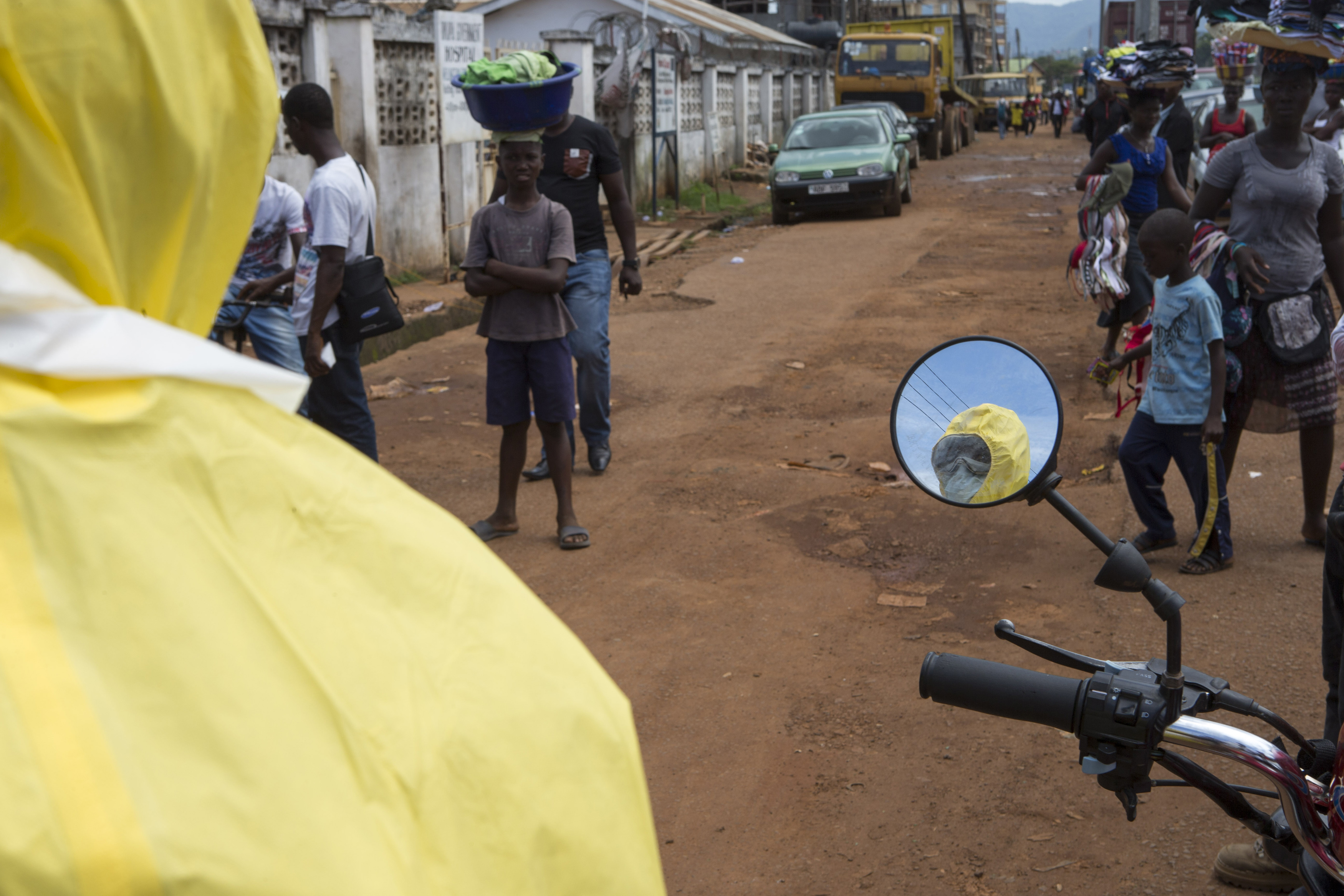 A health worker is reflected in a mirror as he prepares protective equipment in Sierra Leone’s capital city, Freetown. Cuba has dispatched 165 health workers to the country to combat the Ebola outbreak.