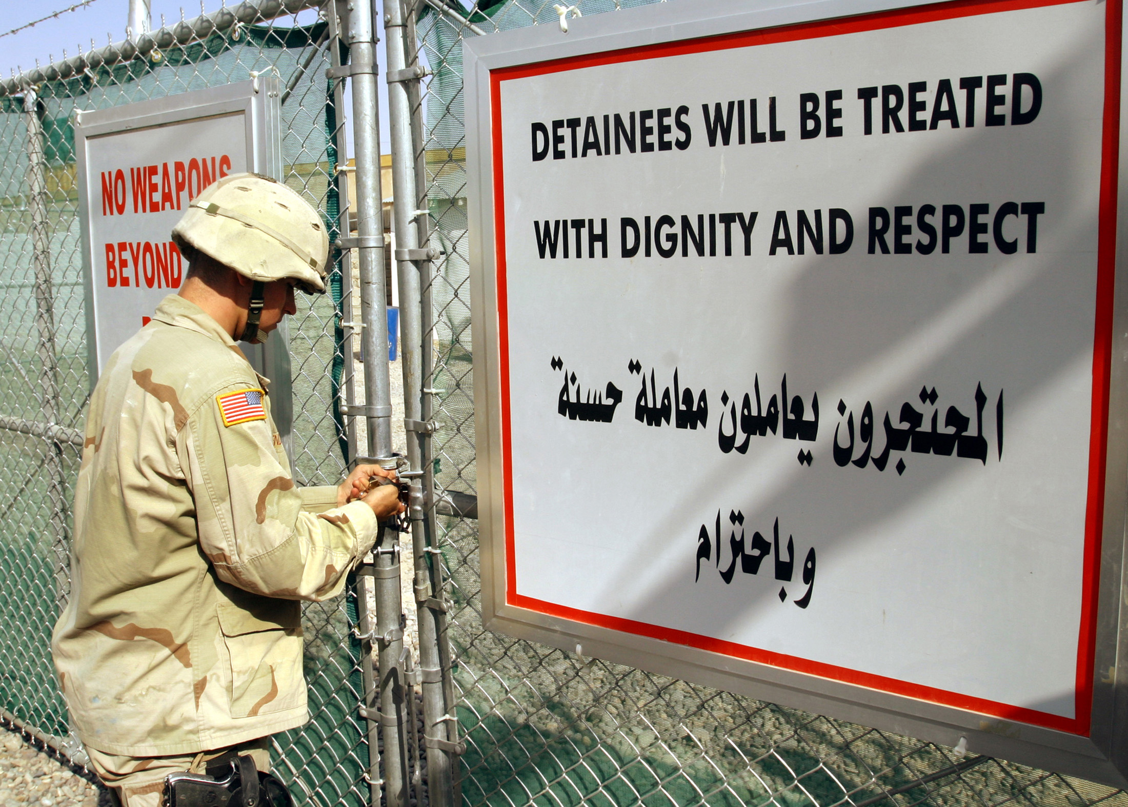 A US Army soldier from the 1st Infantry Division stationed in Tikrit closes the entrance of the dentention center at Forward Operating Base Danger on September 8, 2004. A US Army soldier from the 1st Infantry Division stationed in Tikrit closes the entrance of the dentention center at Forward Operating Base Danger on September 8, 2004.