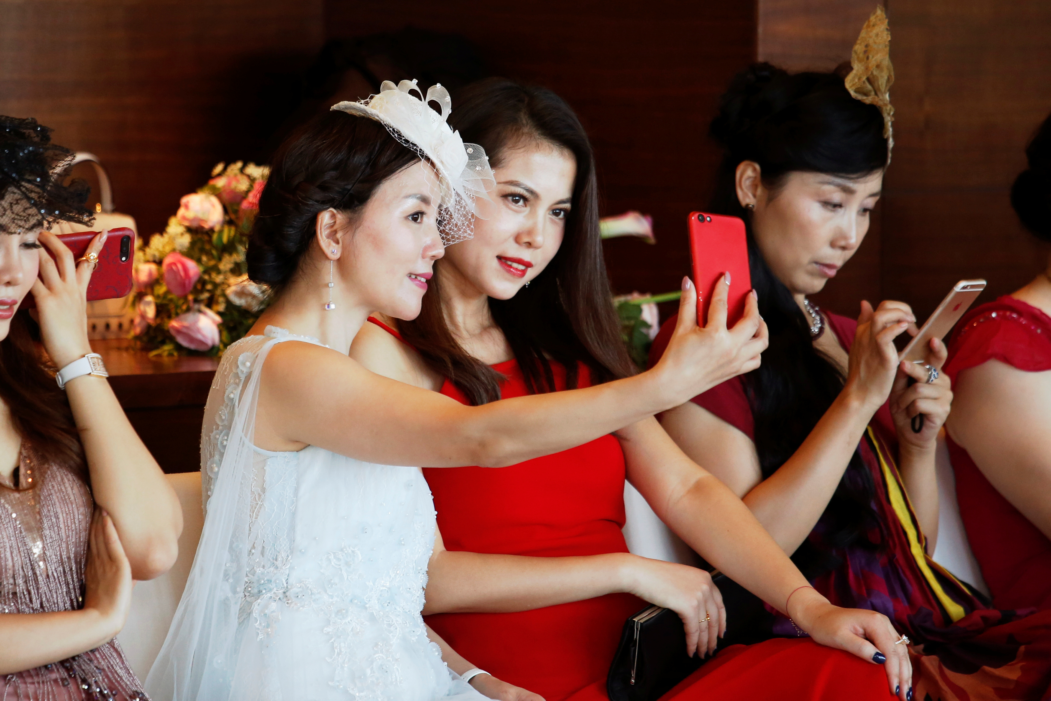 Participants take a selfie during an etiquette class by former Australian model June Dally-Watkins in Guangzhou, China October 8, 2017. Participants take a selfie during an etiquette class by former Australian model June Dally-Watkins in Guangzhou, China October 8, 2017.