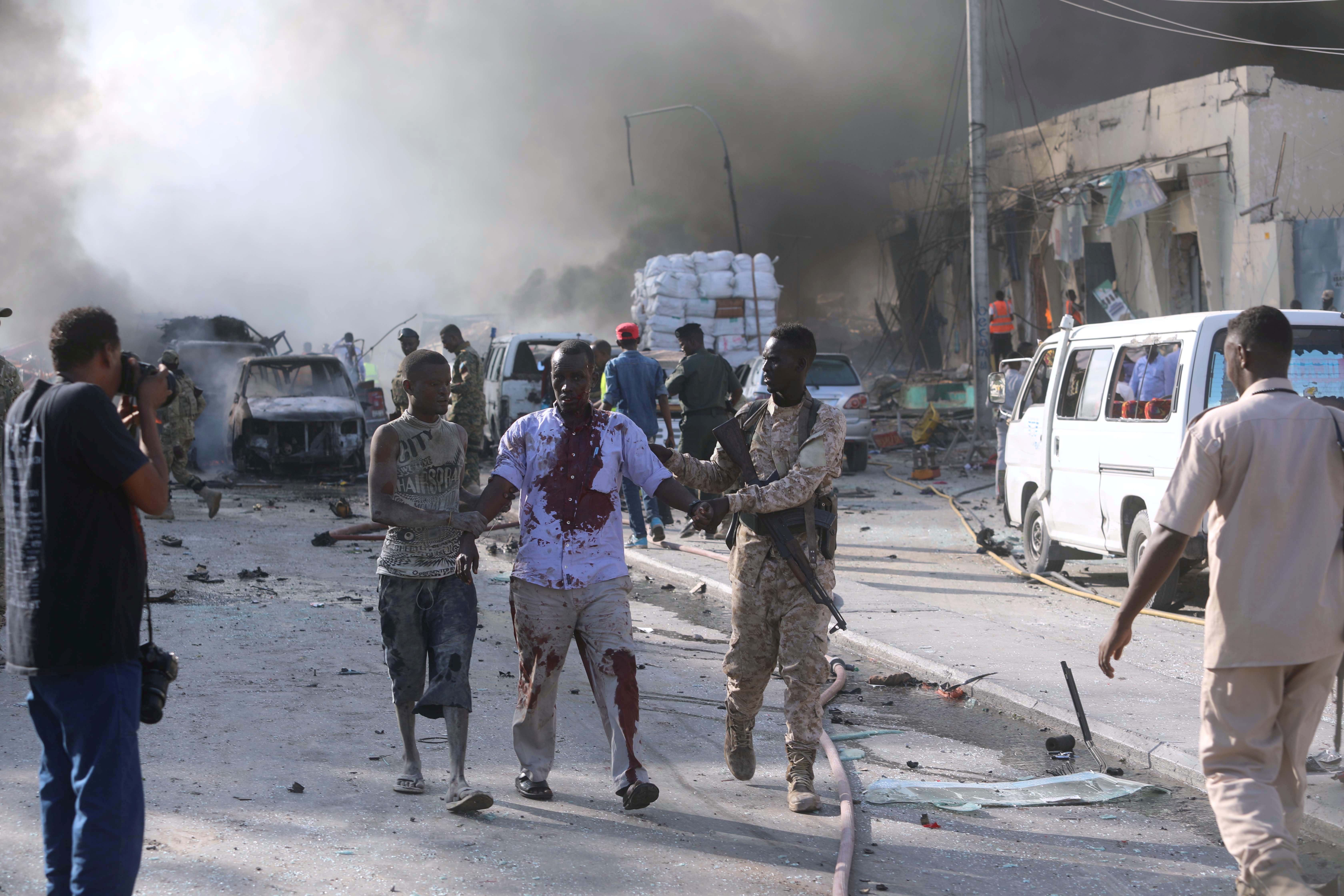 A Somali government soldier evacuates an injured man from the scene of an explosion. A Somali government soldier evacuates an injured man from the scene of an explosion.
