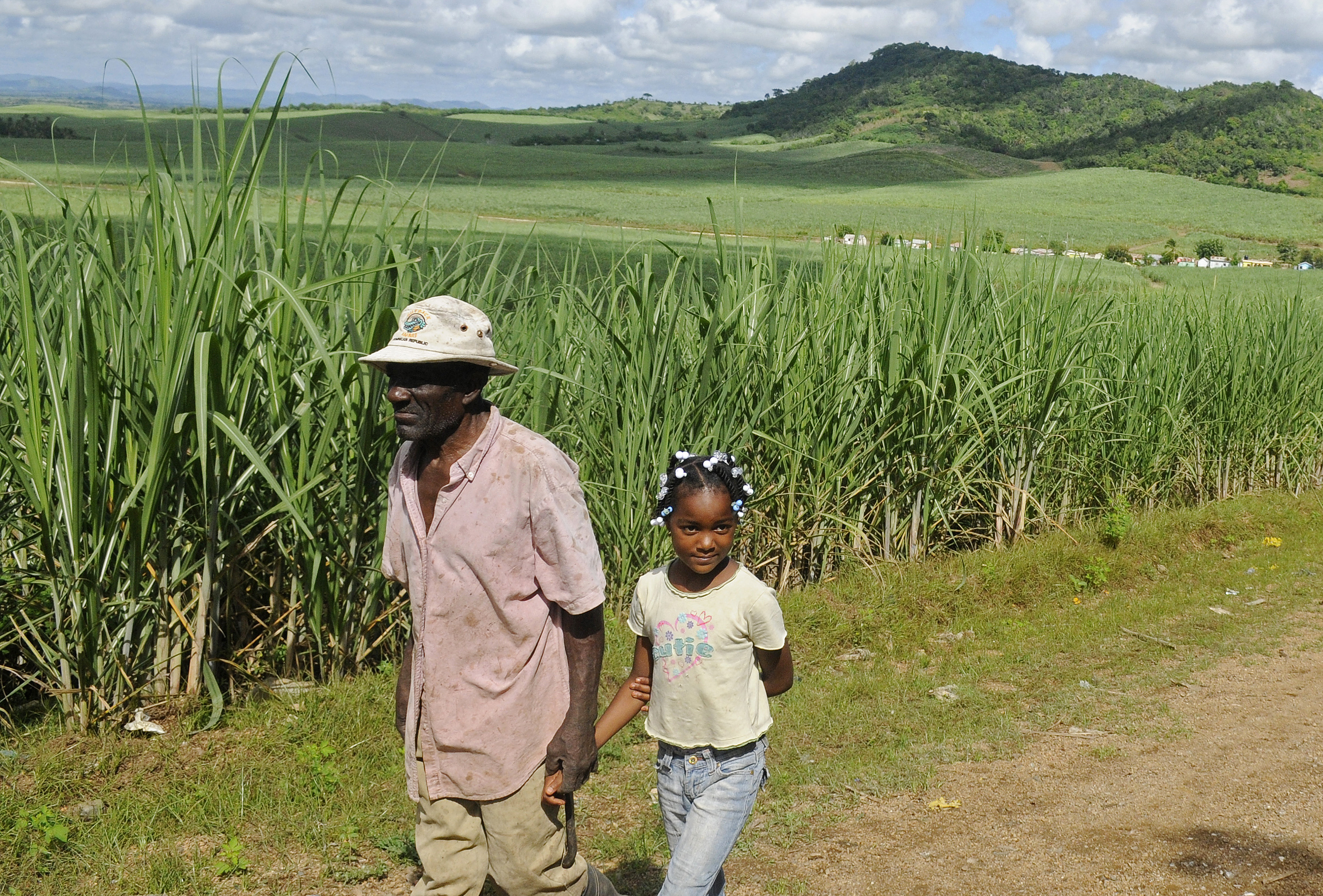 Leguisie Louis (L), a farmer, was born in Haiti but moved to the Dominican Republic in 1959. He's seen here walking with his granddaughter, Maxileidy. A court ruling retroactively denies Dominican nationality to anyone born after 1929 who does not have a Leguisie Louis (L), a farmer, was born in Haiti but moved to the Dominican Republic in 1959. He's seen here walking with his granddaughter, Maxileidy. A court ruling retroactively denies Dominican nationality to anyone born after 1929 who does not have a