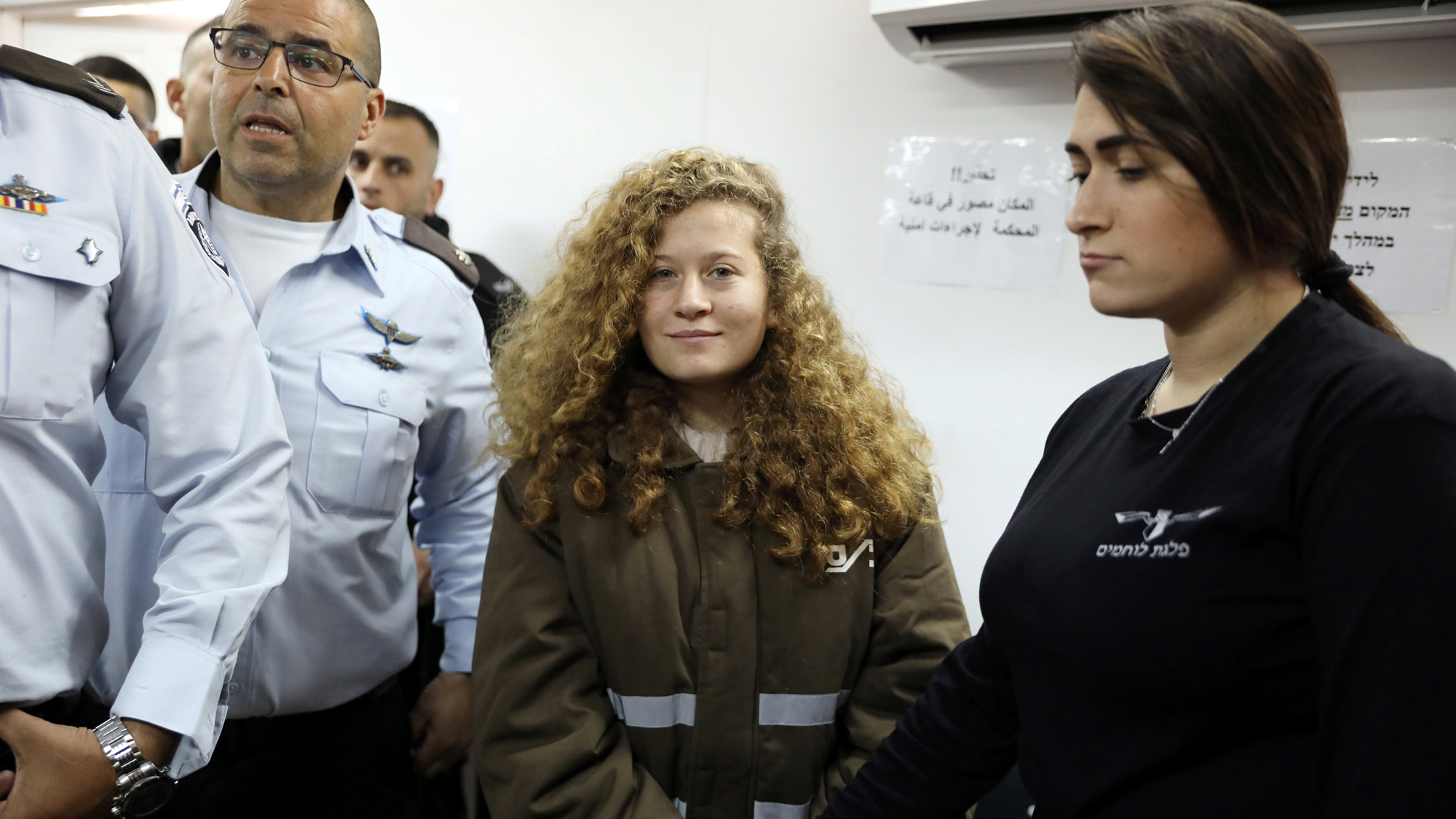 Palestinian teen Ahed Tamimi enters a military courtroom escorted by Israeli security personnel at Ofer Prison, near the West Bank city of Ramallah, Jan. 15, 2018. Palestinian teen Ahed Tamimi enters a military courtroom escorted by Israeli security personnel at Ofer Prison, near the West Bank city of Ramallah, Jan. 15, 2018.