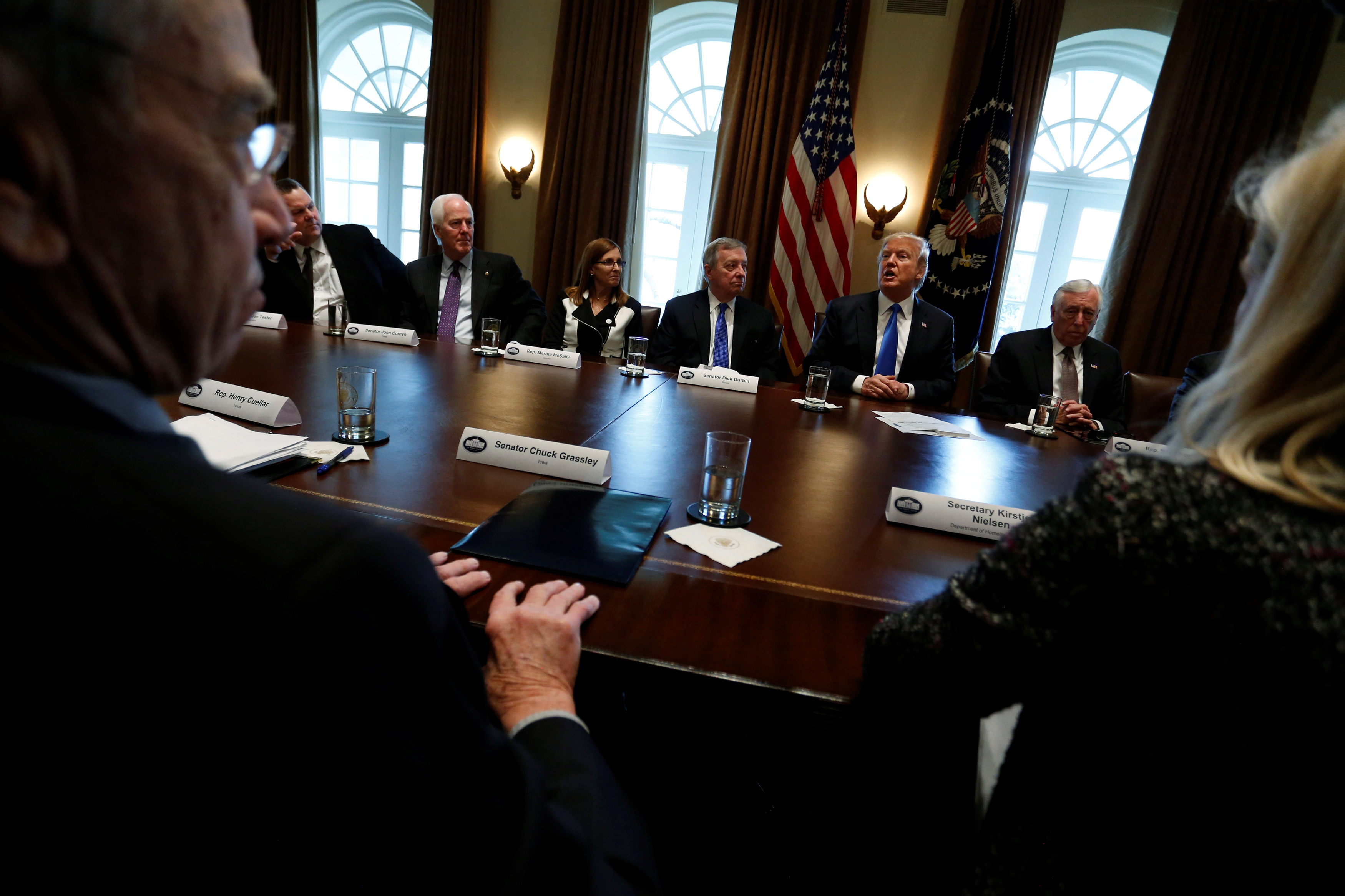 Lawmakers sitting around Trump during an immigration roundtable.