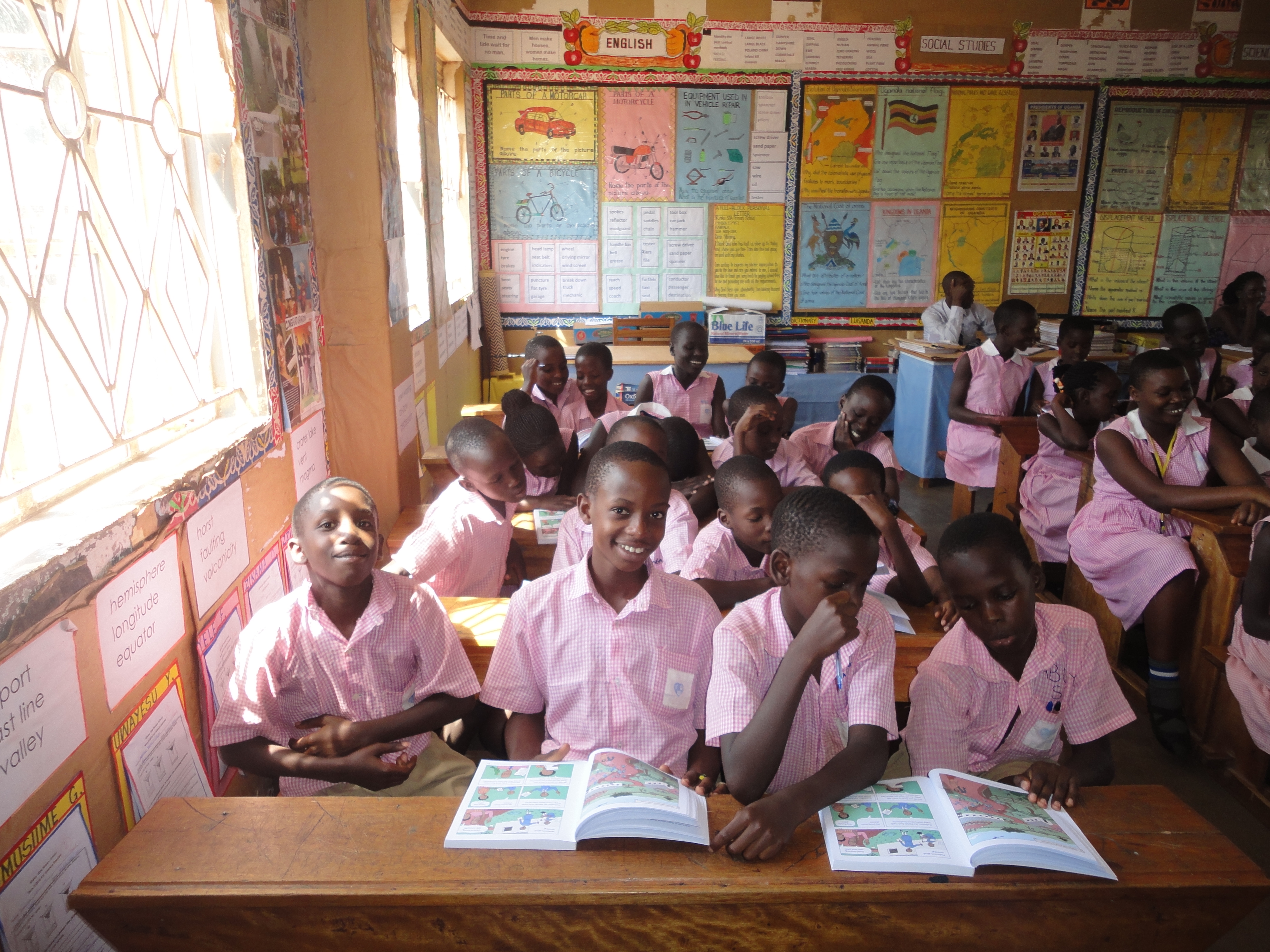 Students use the final version of a children's book to teach kids how to identify false health claims in a classroom in Uganda. Students use the final version of a children's book to teach kids how to identify false health claims in a classroom in Uganda.