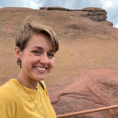 Bianca Hillier wears a yellow shirt and is smiling.