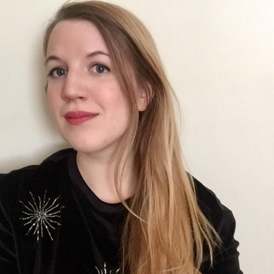 Amanda McGowan a woman in a black sweater posses for a photo.