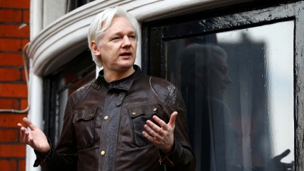 A man stands in front of a window 