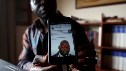 A former UN official campaigning for peace shows a threatening message posted against him on social media by separatists