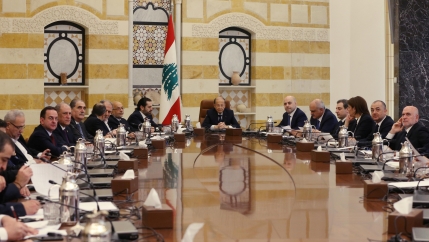 Men sit around a table. 