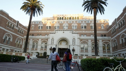 Two students walk on a college campus