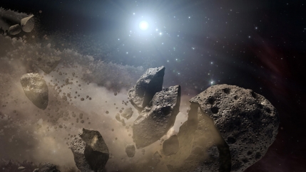 An asteroid breaking into little pieces in space. 
