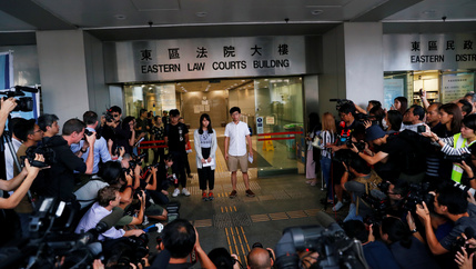 Pro-democracy activists Joshua Wong and Agnes Chow leave the Eastern Court after being released on bail in Hong Kong, China, on August 30, 2019.