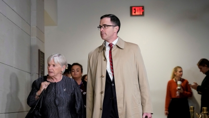 A tall white man and a shorter white woman walking